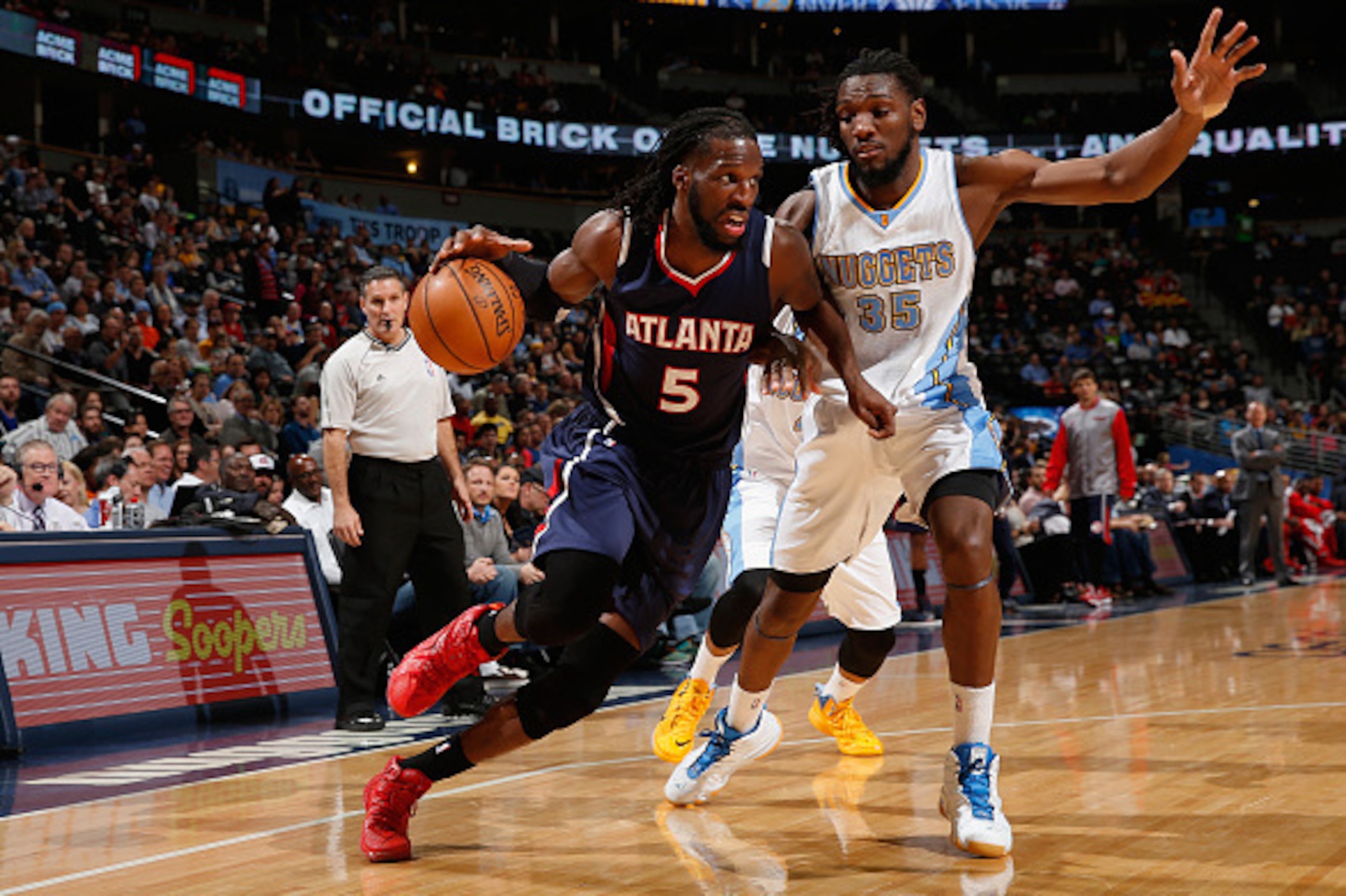 DENVER, CO - MARCH 11:  DeMarre Carroll #5 of the Atlanta Hawks controls the ball against Kenneth Faried #35 of the Denver Nuggets at Pepsi Center on March 11, 2015 in Denver, Colorado. The Nuggets defeated the Hawks 115-102. NOTE TO USER: User expressly 