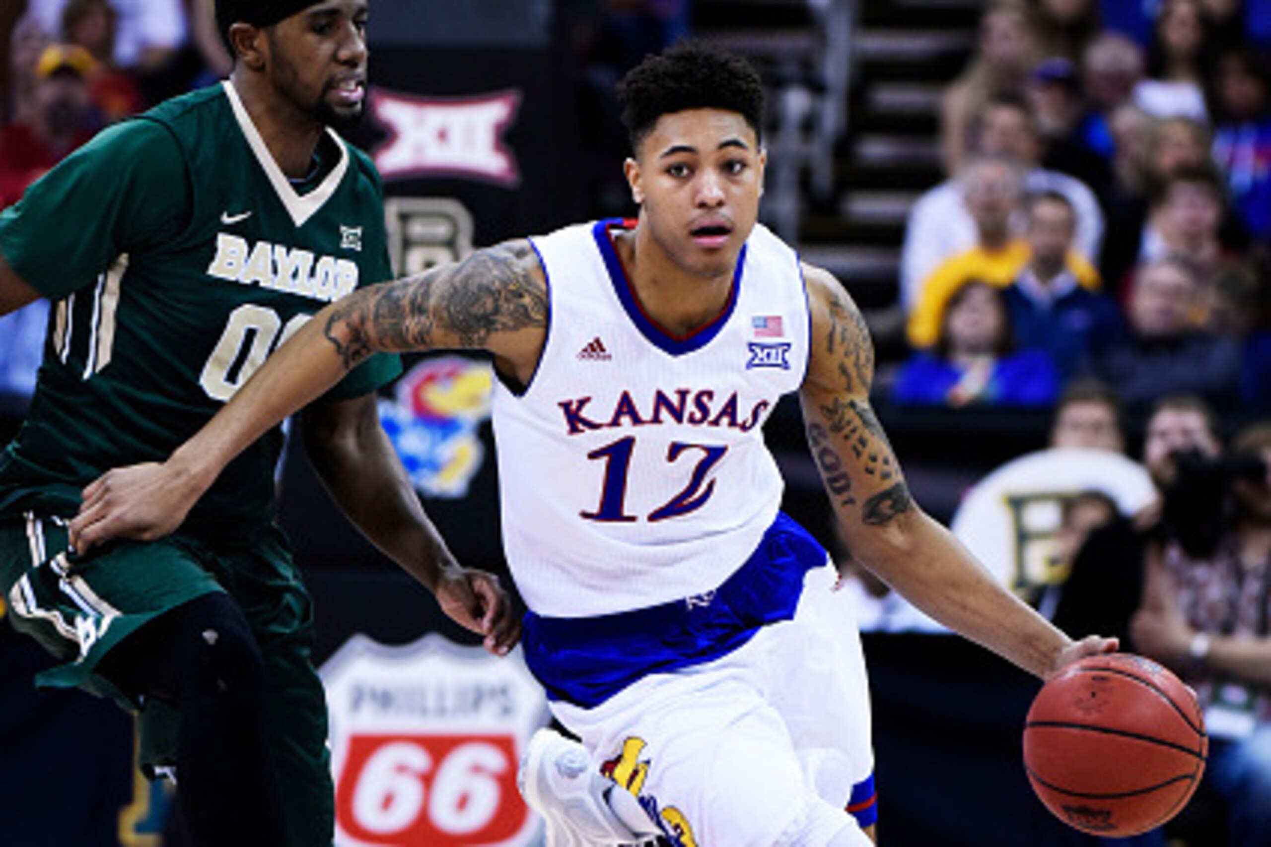 KANSAS CITY, MO - MARCH 13:  Kelly Oubre Jr. #12 of the Kansas Jayhawks drives past Royce O'Neale #00 of the Baylor Bears in the second half during a semifinal game of the 2015 Big 12 Basketball Tournament at Sprint Center on March 13, 2015 in Kansas City