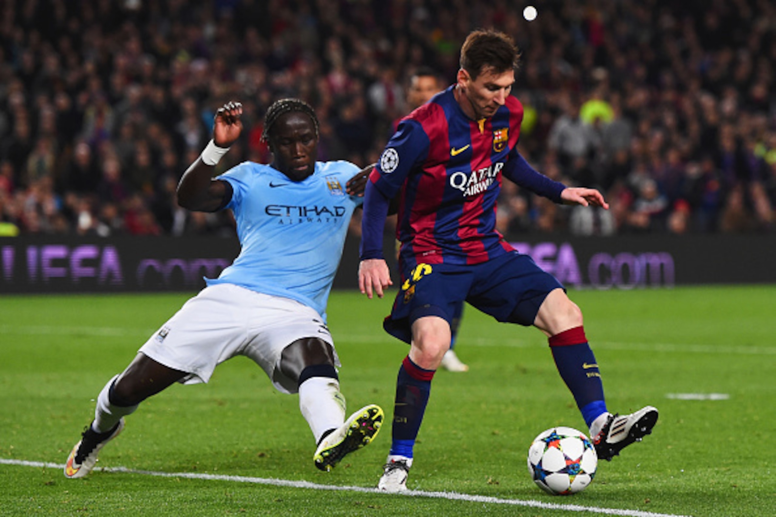 BARCELONA, SPAIN - MARCH 18: Lionel Messi of Barcelona is tackled by Bacary Sagna of Manchester City during the UEFA Champions League Round of 16 second leg match between Barcelona and Manchester City at Camp Nou on March 18, 2015 in Barcelona, Spain.  (P