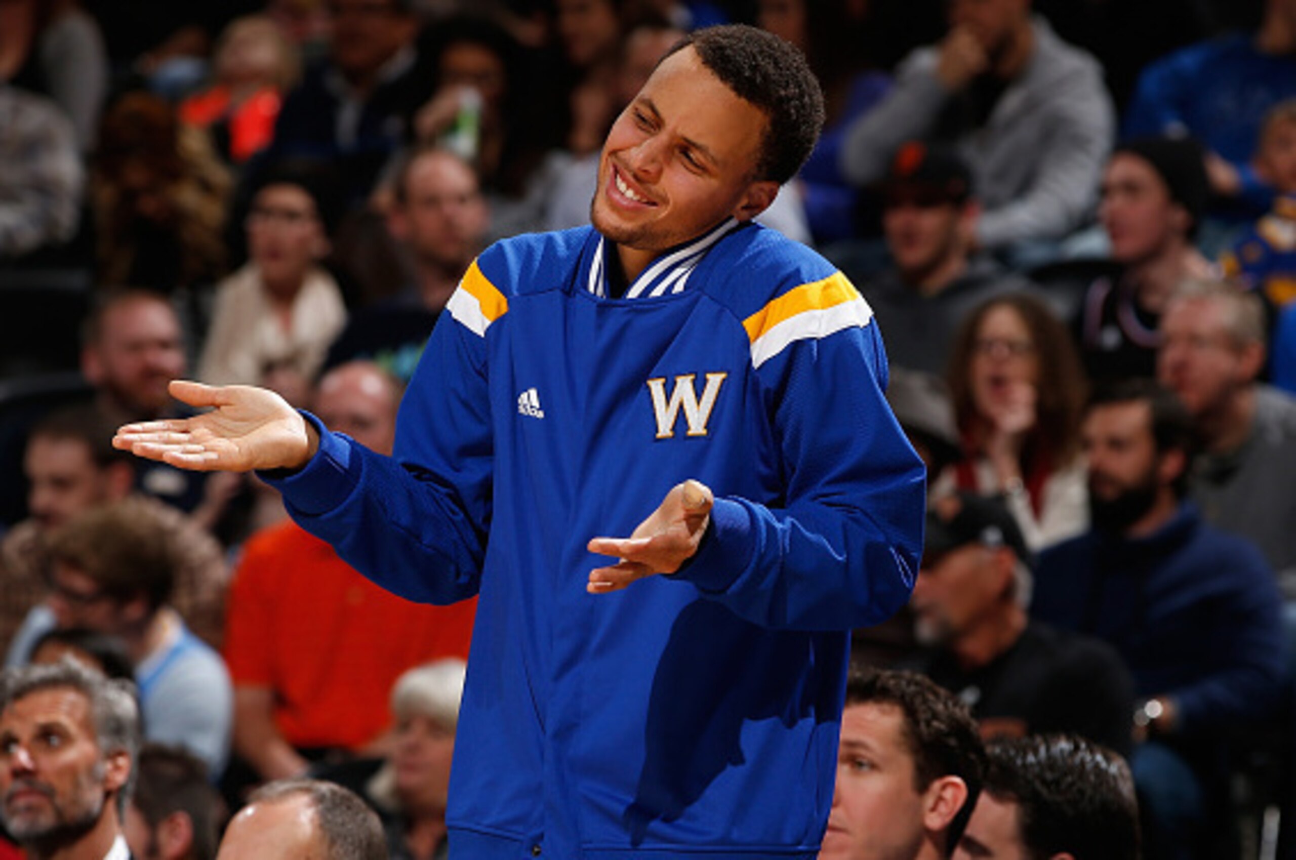 DENVER, CO - MARCH 13:  Stephen Curry #30 of the Golden State Warriors supports his teammates from the bench against the Denver Nuggets at Pepsi Center on March 13, 2015 in Denver, Colorado. NOTE TO USER: User expressly acknowledges and agrees that, by do