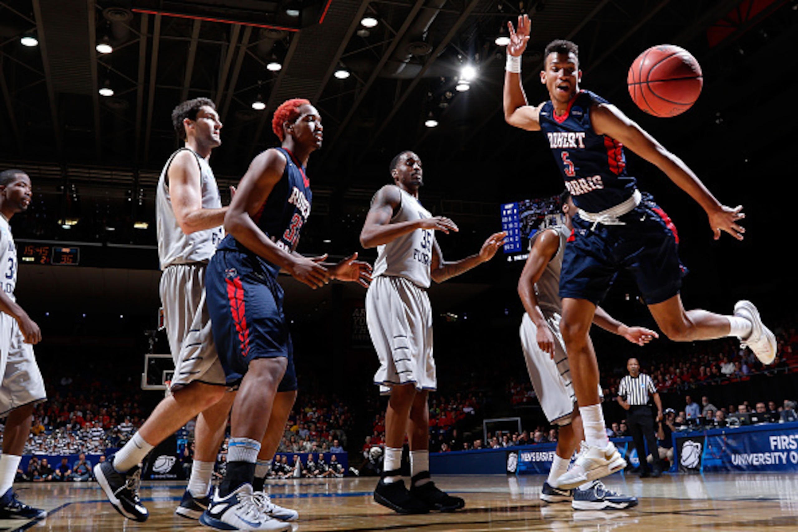 DAYTON, OH - MARCH 18: Elijah Minnie #5 of the Robert Morris Colonials loses control of the ball against the North Florida Ospreys during the first round of the 2015 NCAA Men's Basketball Tournament at UD Arena on March 18, 2015 in Dayton, Ohio. (Photo b DAYTON, OH - MARCH 18: Elijah Minnie #5 of the Robert Morris Colonials loses control of the ball against the North Florida Ospreys during the first round of the 2015 NCAA Men's Basketball Tournament at UD Arena on March 18, 2015 in Dayton, Ohio. (Photo b