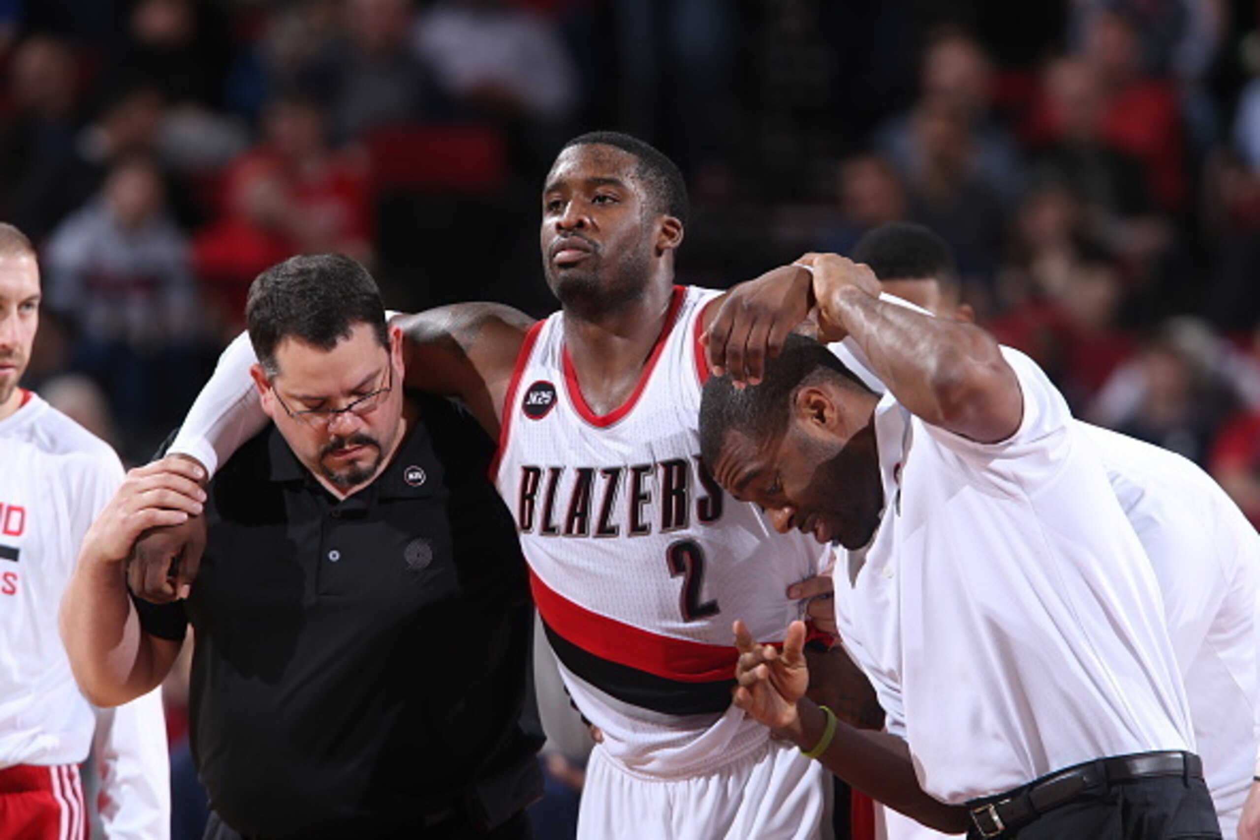 PORTLAND, OR - MARCH 5: Wesley Matthews #2 of the Portland Trail Blazers gets helped off the court during a game against the Dallas Mavericks on March 5, 2015 at the Moda Center Arena in Portland, Oregon. NOTE TO USER: User expressly acknowledges and agre