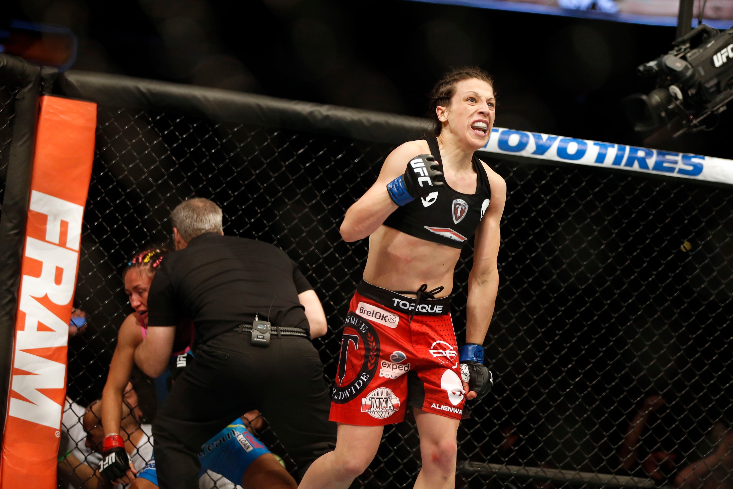 Mar 14, 2015; Dallas, TX, USA; Joanna Jedrzejczyk (blue) celebrates defeating Carla Esparza (red) in the women's strawweight title bout during UFC 185 at American Airlines Center. Mandatory Credit: Tim Heitman-USA TODAY Sports Mar 14, 2015; Dallas, TX, USA; Joanna Jedrzejczyk (blue) celebrates defeating Carla Esparza (red) in the women's strawweight title bout during UFC 185 at American Airlines Center. Mandatory Credit: Tim Heitman-USA TODAY Sports
