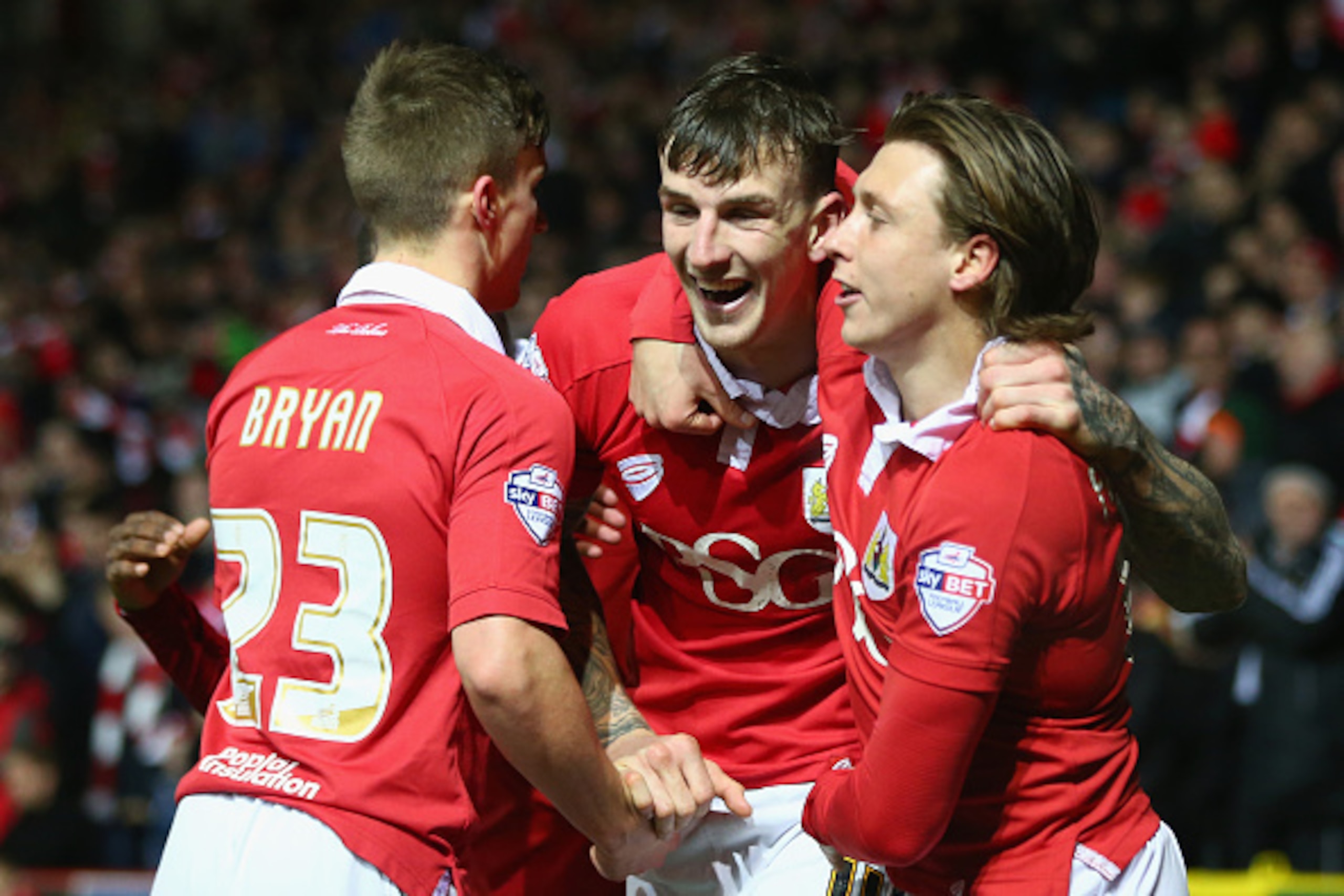 BRISTOL, ENGLAND - FEBRUARY 17:  Aden Flint (C) of Bristol City celebrates  scoring the opening goal with Luke Freeman (R) and Joe Bryan (L) during the Sky Bet League One match between Bristol City and Peterborough United at Ashton Gate on February 17, 20