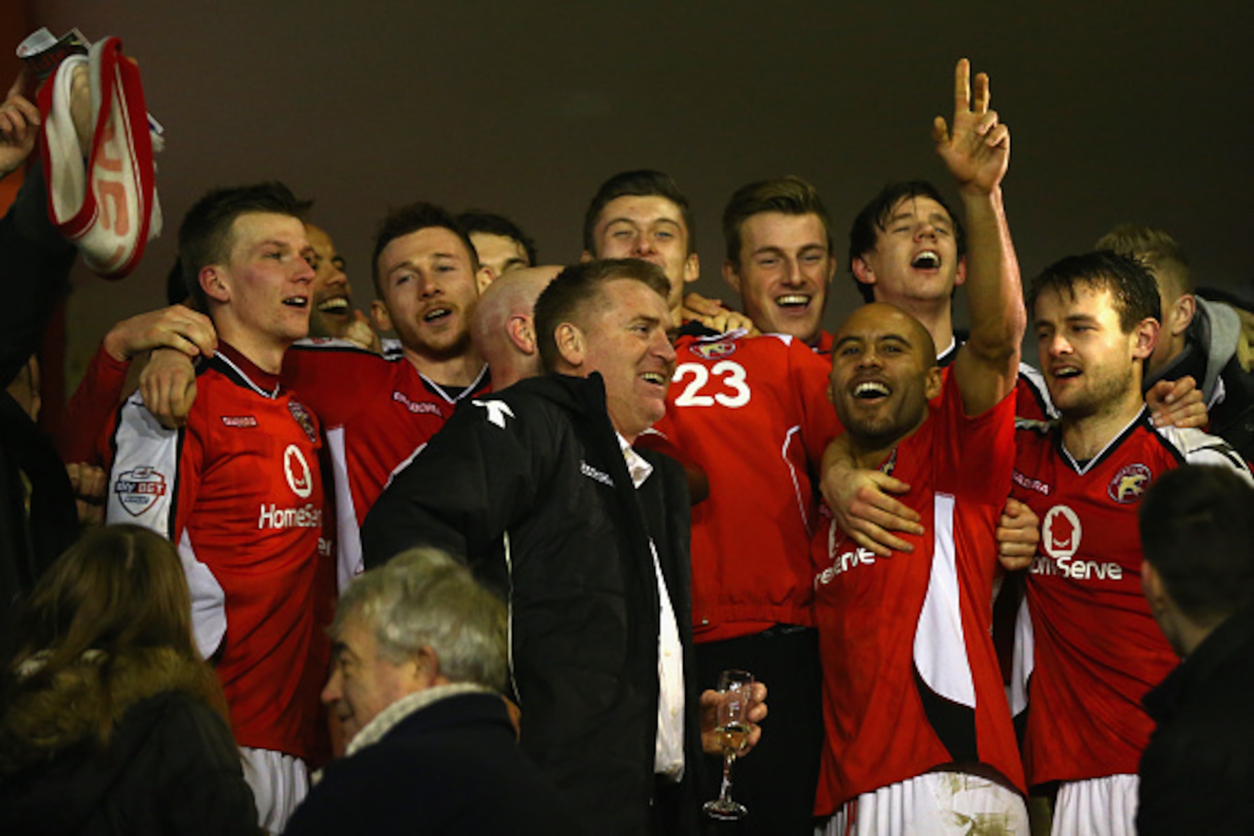 WALSALL, ENGLAND - JANUARY 27:  Dean Smith (C) the manager of Walsall flanked by James Chambers (2R) celebrate reaching the final after their 2-0 victory during the Johnstone's Paint Northern Area Final second leg match between Walsall and Preston North E