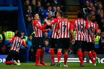 LONDON, ENGLAND - MARCH 15:  Dusan Tadic of Southampton (L) celebrates scoring their first goal with Morgan Schneiderlin and team mates during the Barclays Premier League match between Chelsea and Southampton at Stamford Bridge on March 15, 2015 in London