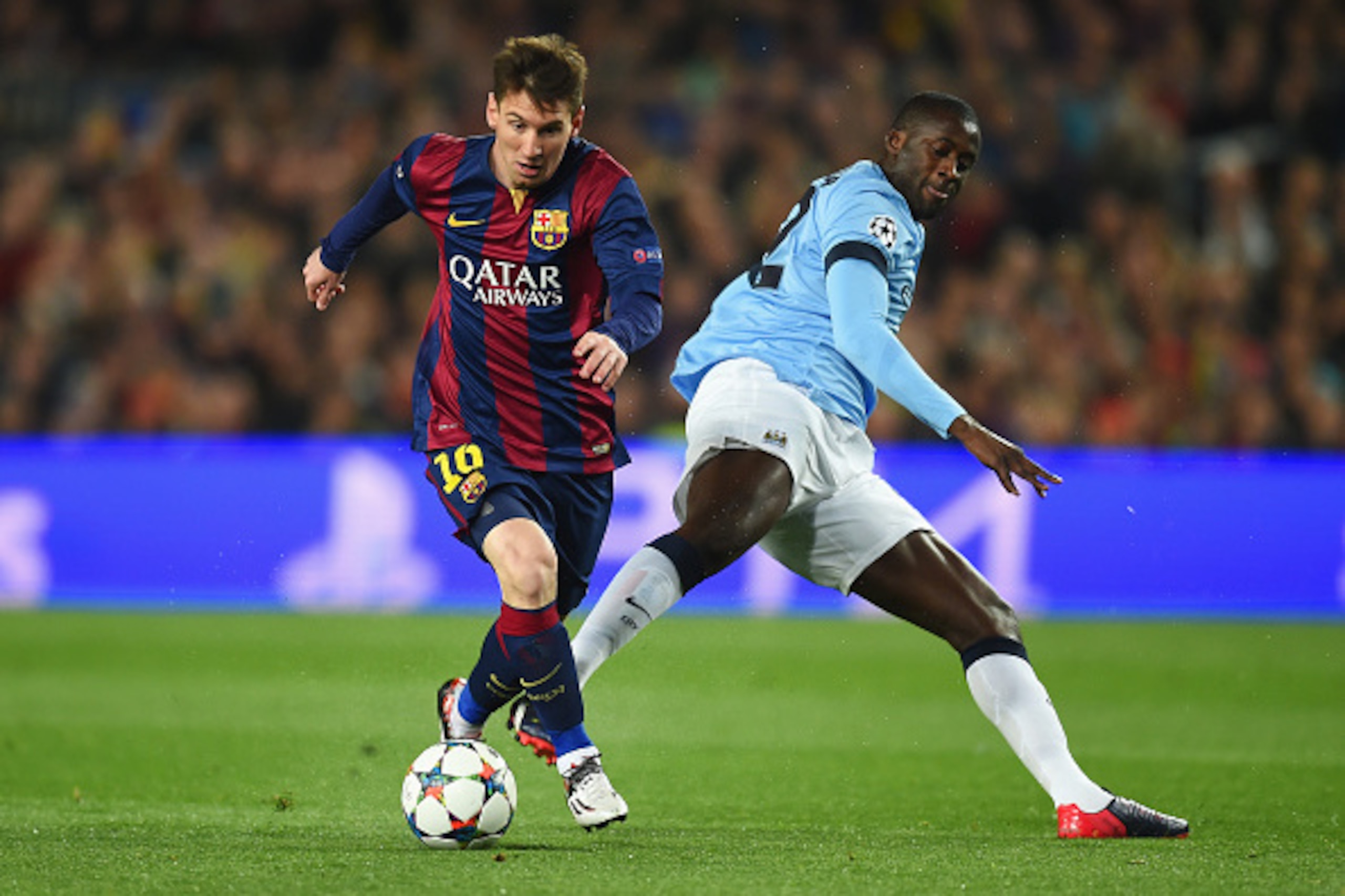 BARCELONA, SPAIN - MARCH 18: Lionel Messi of Barcelona is challenged by Yaya Toure of Manchester City during the UEFA Champions League Round of 16 second leg match between Barcelona and Manchester City at Camp Nou on March 18, 2015 in Barcelona, Spain.  (