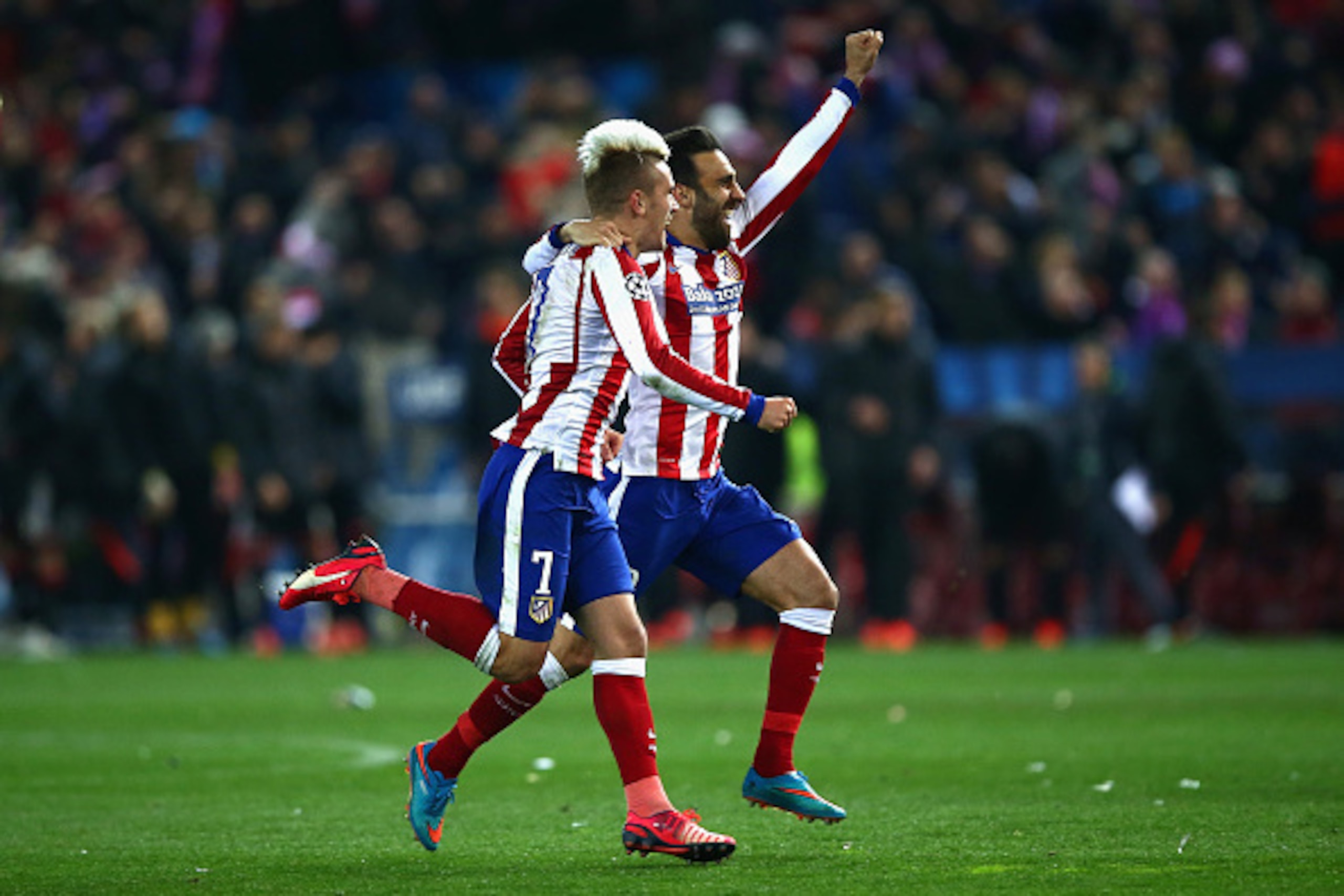 MADRID, SPAIN - MARCH 17:  Antoine Griezmann and Jesus Gamez of Atletico Madrid celebrate after the penalty shoot out the UEFA Champions League round of 16 match between Club Atletico de Madrid and Bayer 04 Leverkusen at Vicente Calderon Stadium on March 