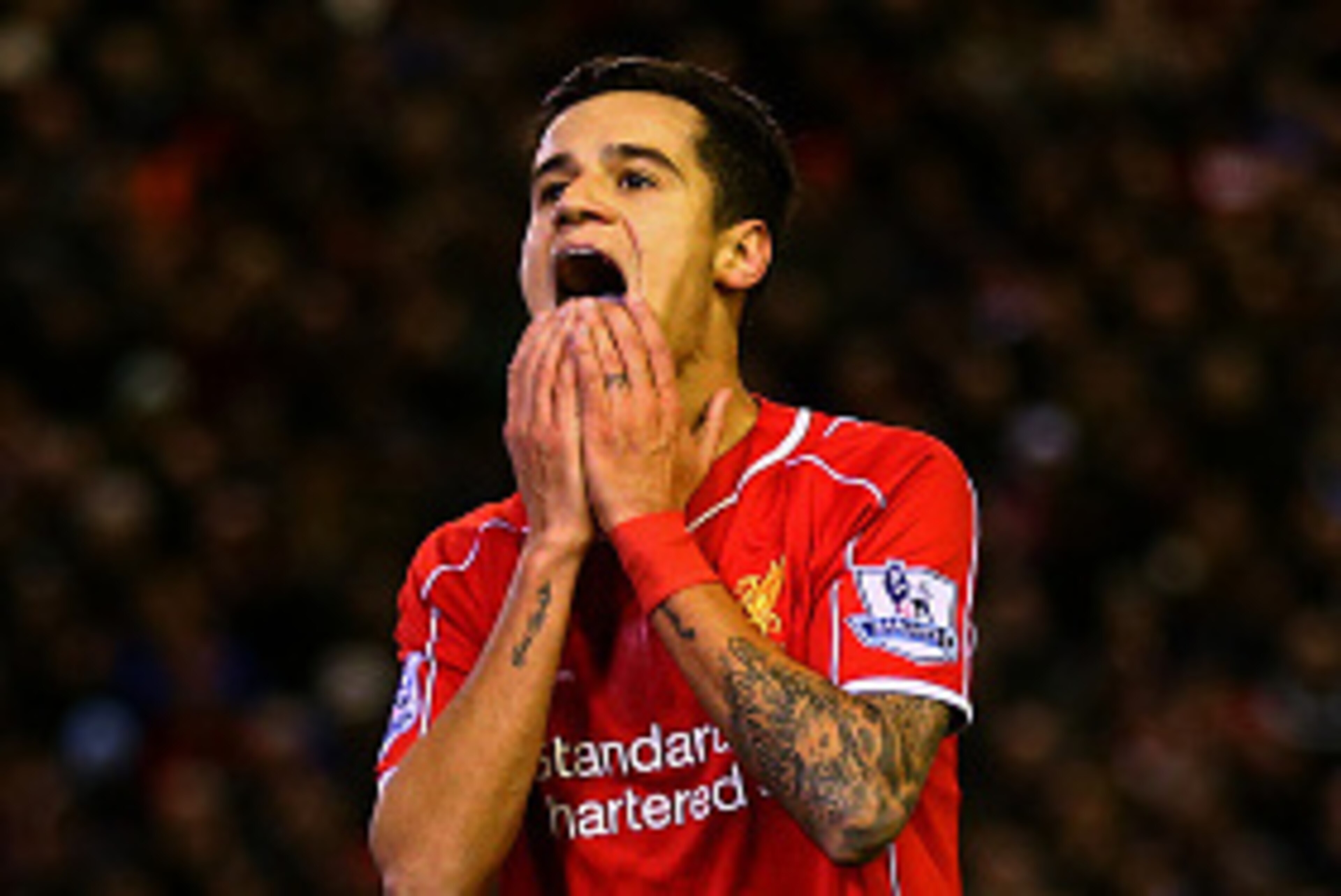 LIVERPOOL, ENGLAND - DECEMBER 29:  Philippe Coutinho of Liverpool reacts after a missed opportunity during the Barclays Premier League match between Liverpool and Swansea City at Anfield on December 29, 2014 in Liverpool, England.  (Photo by Clive Brunski