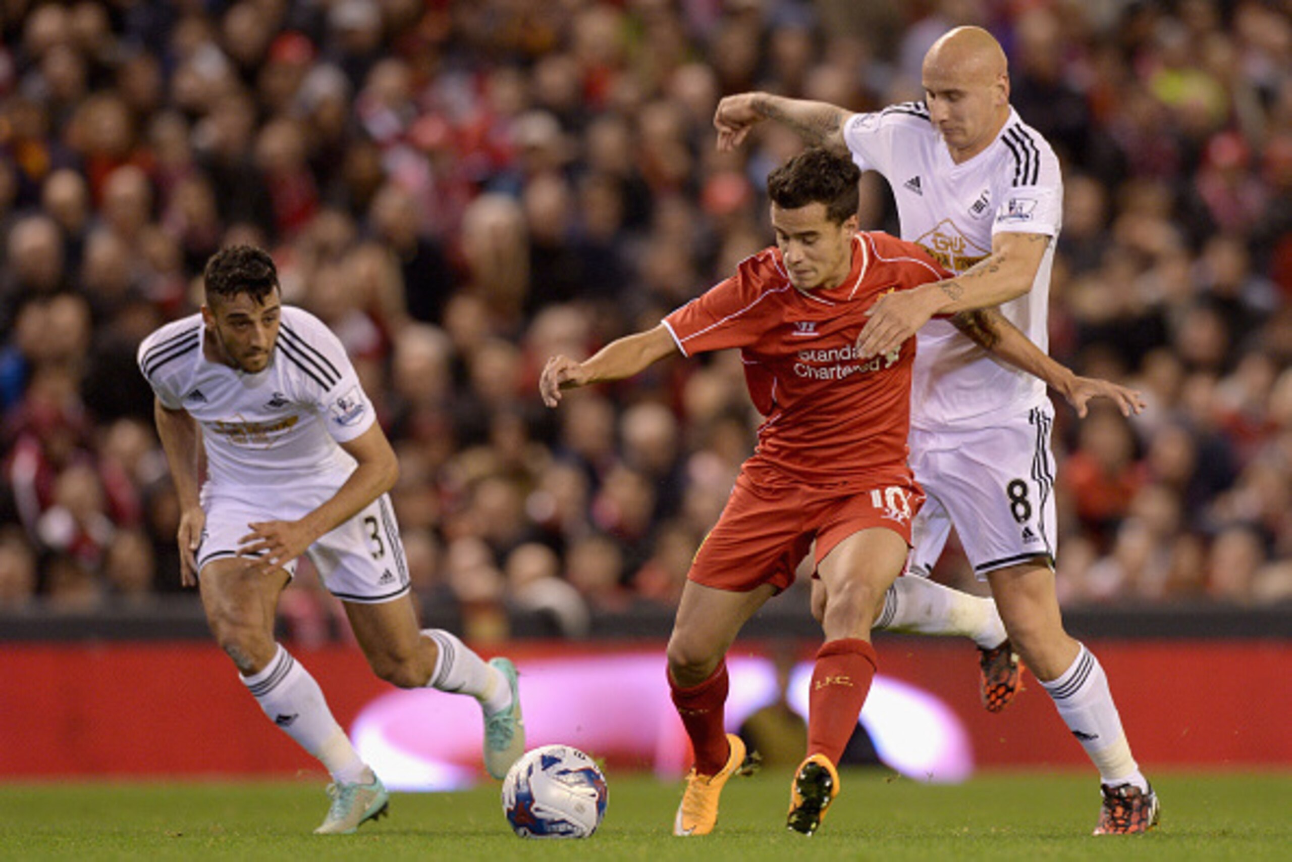 LIVERPOOL, ENGLAND - OCTOBER 28:  Philippe Coutinho of Liverpool is tackled by Jonjo Shelvey of Swansea during the Capital One Cup Fourth Round match between Liverpool and Swansea City at Anfield on October 28, 2014 in Liverpool, England.  (Photo by Garet