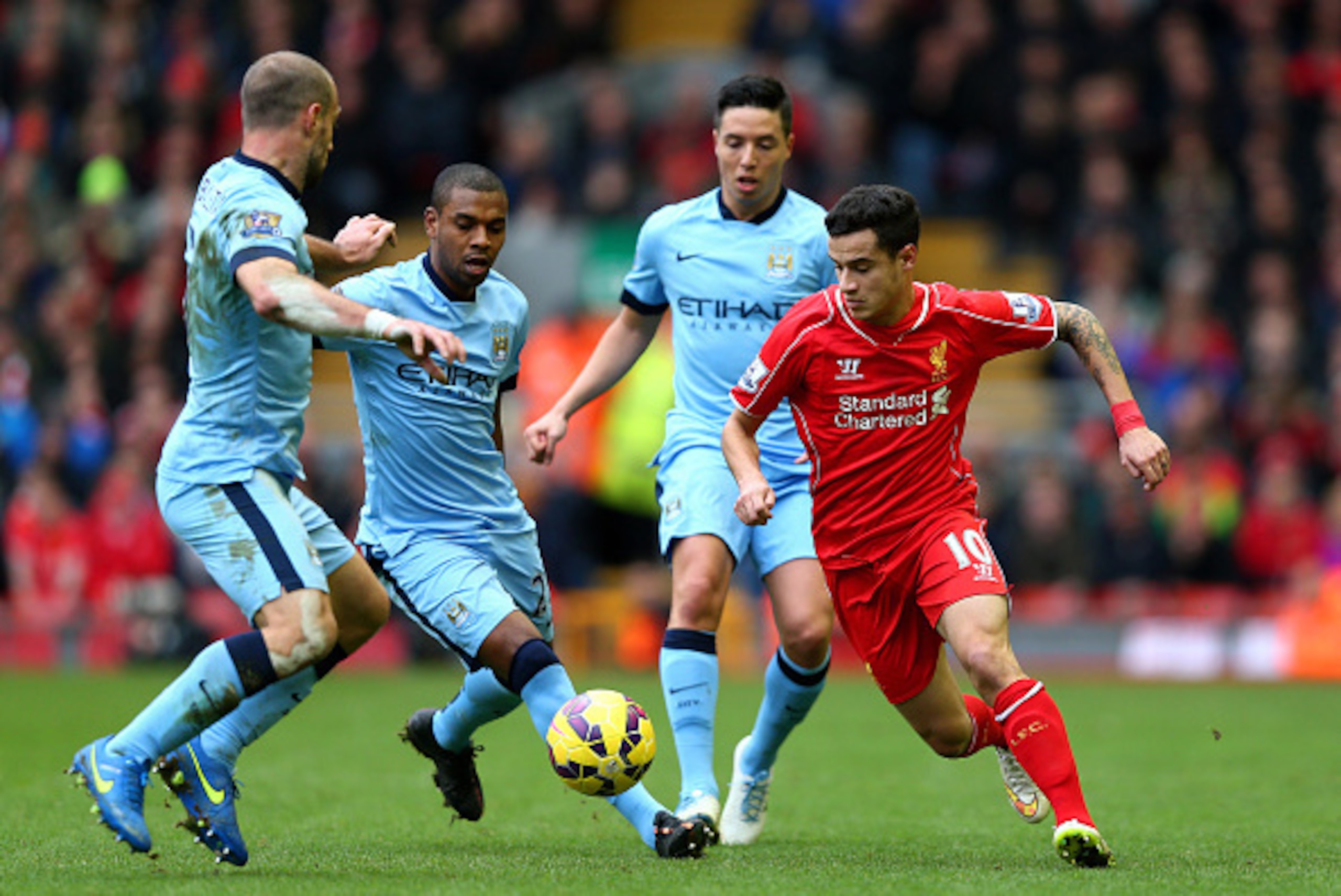 LIVERPOOL, ENGLAND - MARCH 01:  Philippe Coutinho of Liverpool is closed down by Manchester City defence during the Barclays Premier League match between Liverpool and Manchester City at Anfield on March 1, 2015 in Liverpool, England.  (Photo by Clive Bru
