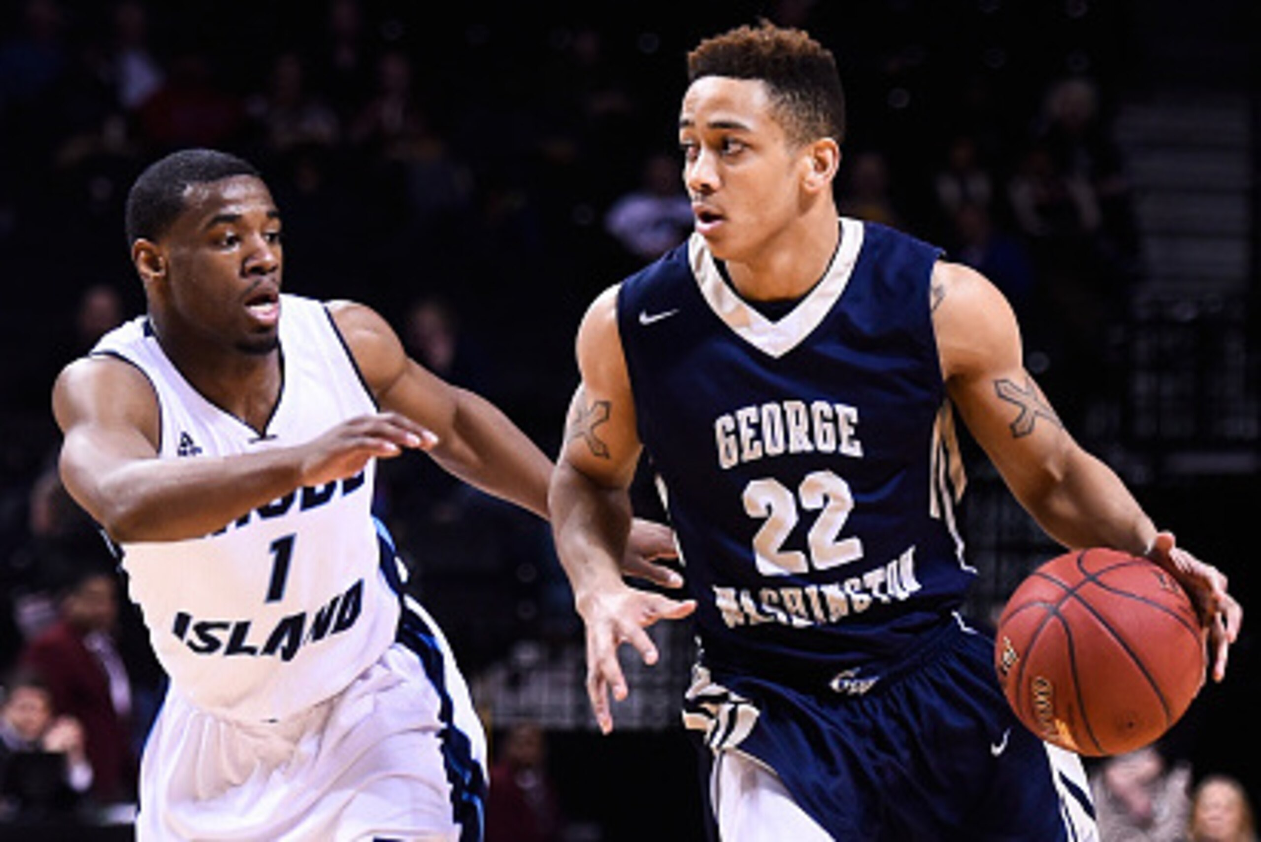 NEW YORK, NY - MARCH 13:  Joe McDonald #22 of the George Washington Colonials attempts to drive past Jarvis Garrett #1 of the Rhode Island Rams during a quarterfinal game in the 2015 Men's Atlantic 10 Basketball Tournament at the Barclays Center on March 