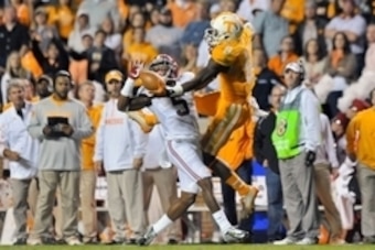 Oct 25, 2014; Knoxville, TN, USA; Alabama Crimson Tide defensive back Cyrus Jones (5) gets the pass interference call as he attempts to break up a pass intended for Tennessee Volunteers wide receiver Marquez North (8) during the first half game at Neyland