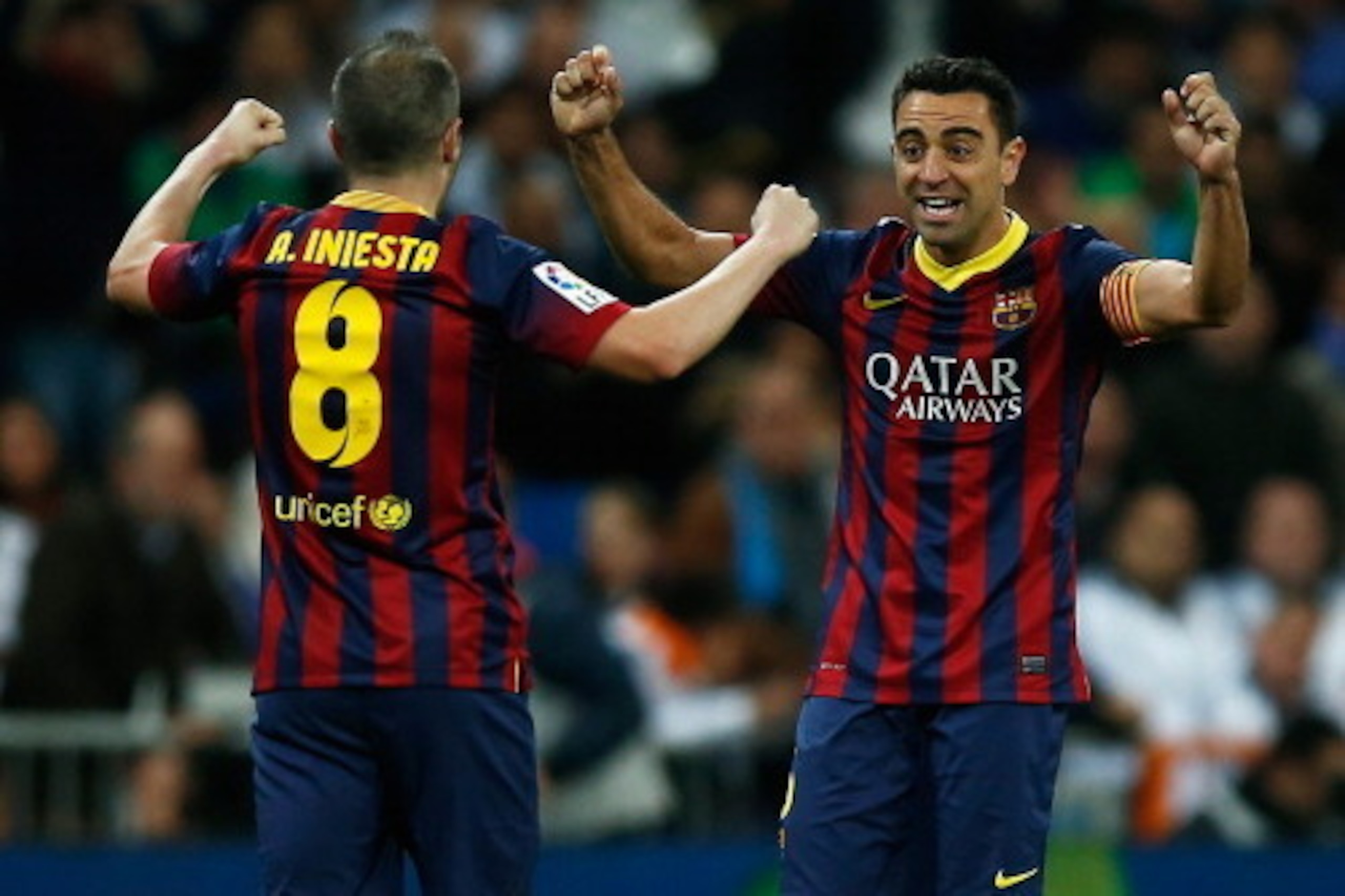MADRID, SPAIN - MARCH 23: Xavi (R) of Barcelona celebrates victory with Andres Iniesta after the La Liga match between Real Madrid CF and FC Barcelona at the Bernabeu on March 23, 2014 in Madrid, Spain.  (Photo by Gonzalo Arroyo Moreno/Getty Images)