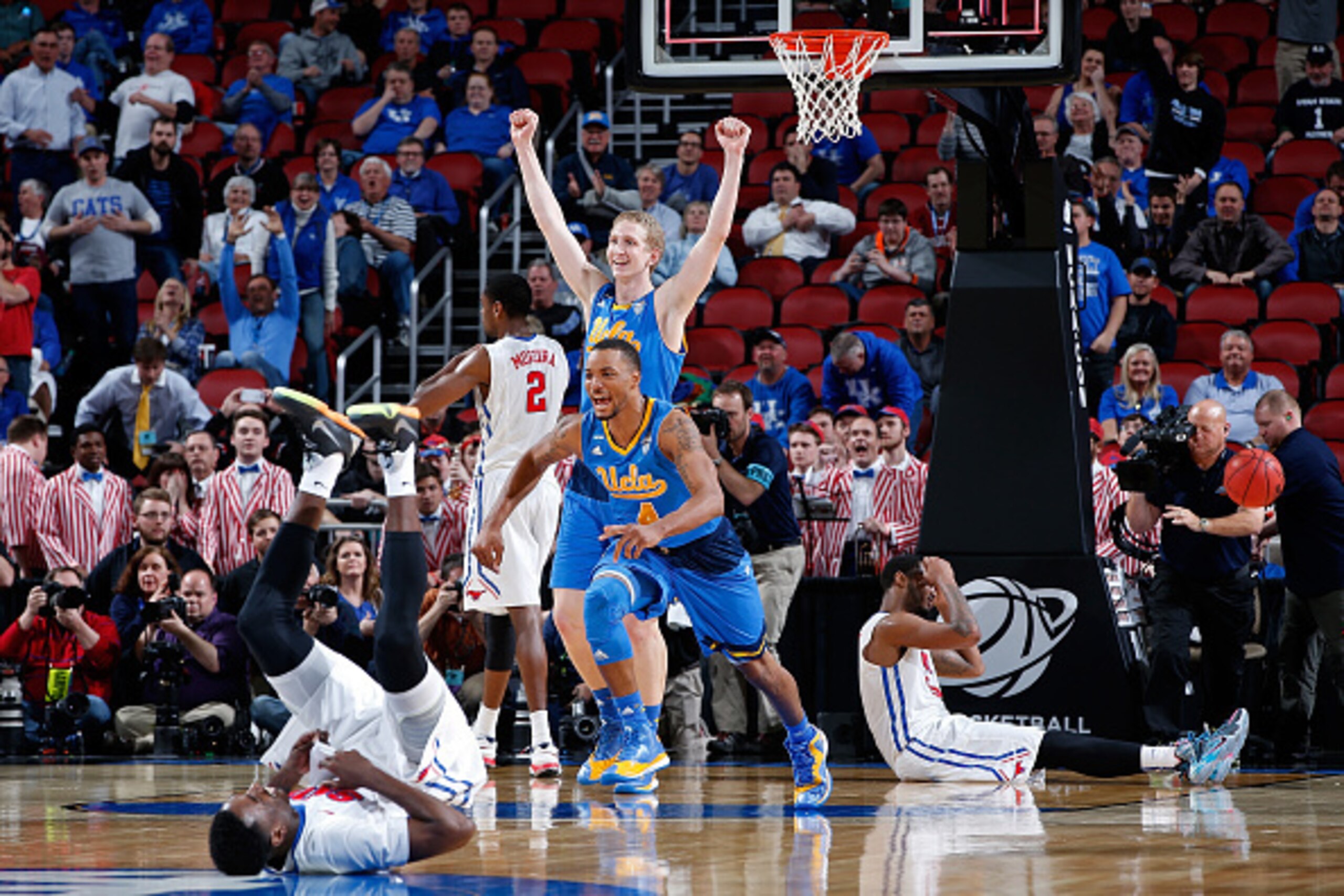 LOUISVILLE, KY - MARCH 19:  Thomas Welsh #40 and Norman Powell #4 of the UCLA Bruins reacts after defeating the Southern Methodist Mustangs during the second round of the 2015 NCAA Men's Basketball Tournamenat at the KFC YUM! Center on March 19, 2015 in L