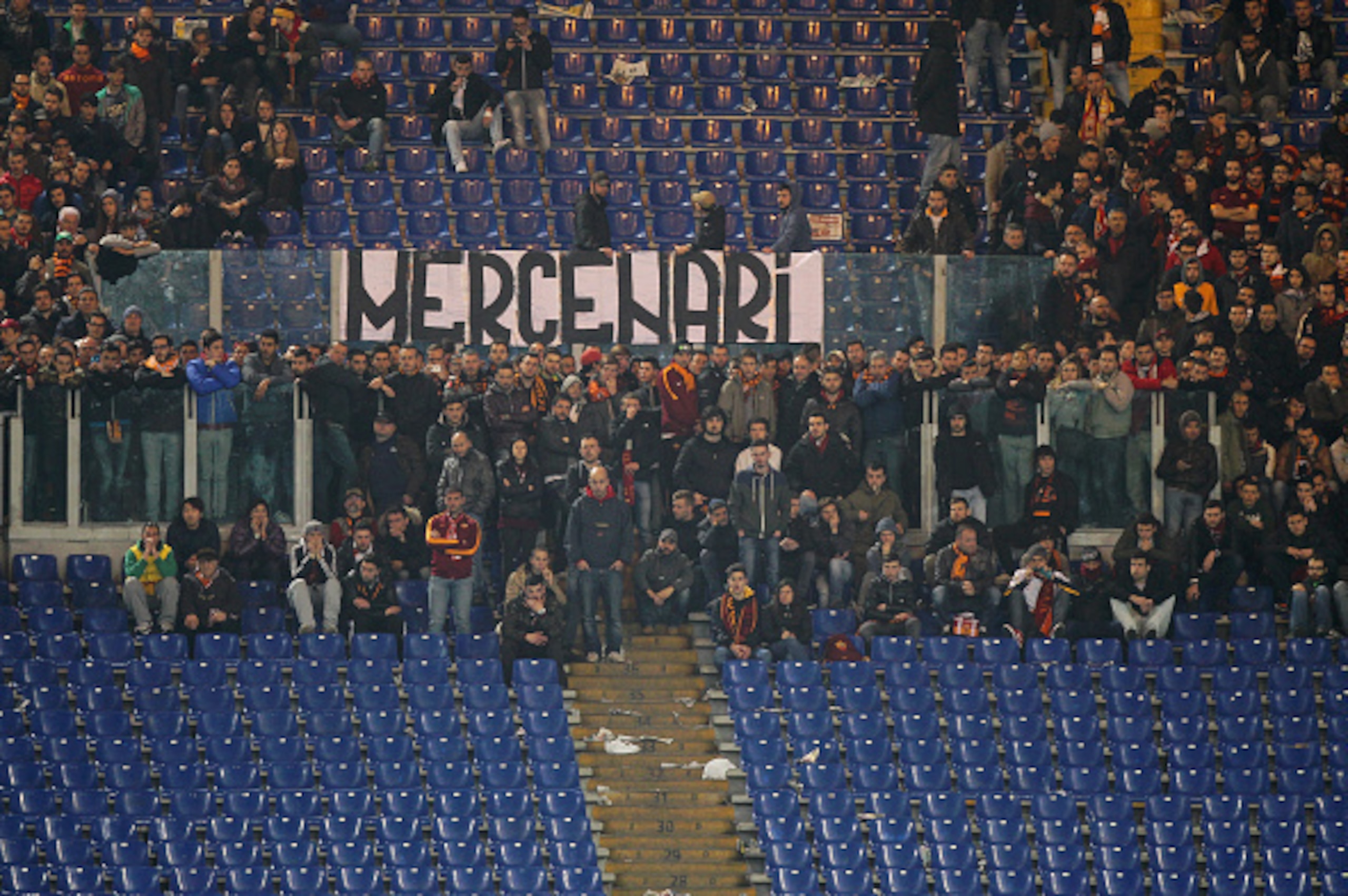 ROME, ITALY - MARCH 19: AS Roma fans show a banner with a written 'Mercenari' (Mercenaries) during the UEFA Europa League Round of 16 match between AS Roma and ACF Fiorentina at Olimpico Stadium on March 19, 2015 in Rome, Italy.  (Photo by Paolo Bruno/Get
