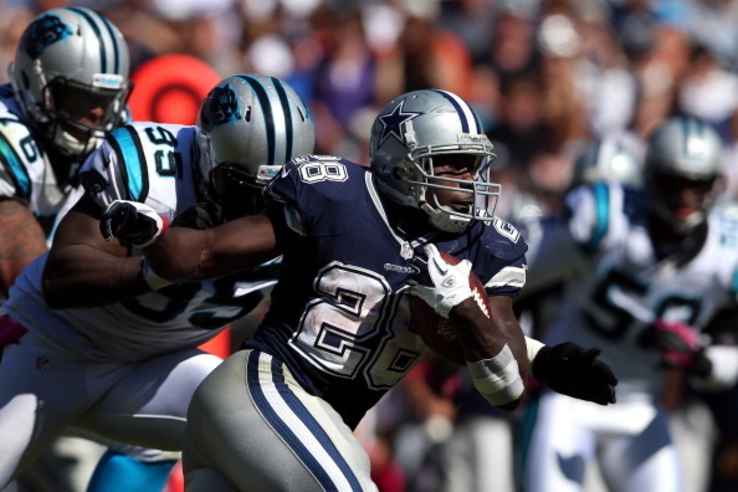 CHARLOTTE, NC - OCTOBER 21:   Charles Johnson #95 of the Carolina Panthers tackles  Felix Jones #28 of the Dallas Cowboys during their game at Bank of America Stadium on October 21, 2012 in Charlotte, North Carolina.  (Photo by Streeter Lecka/Getty Images