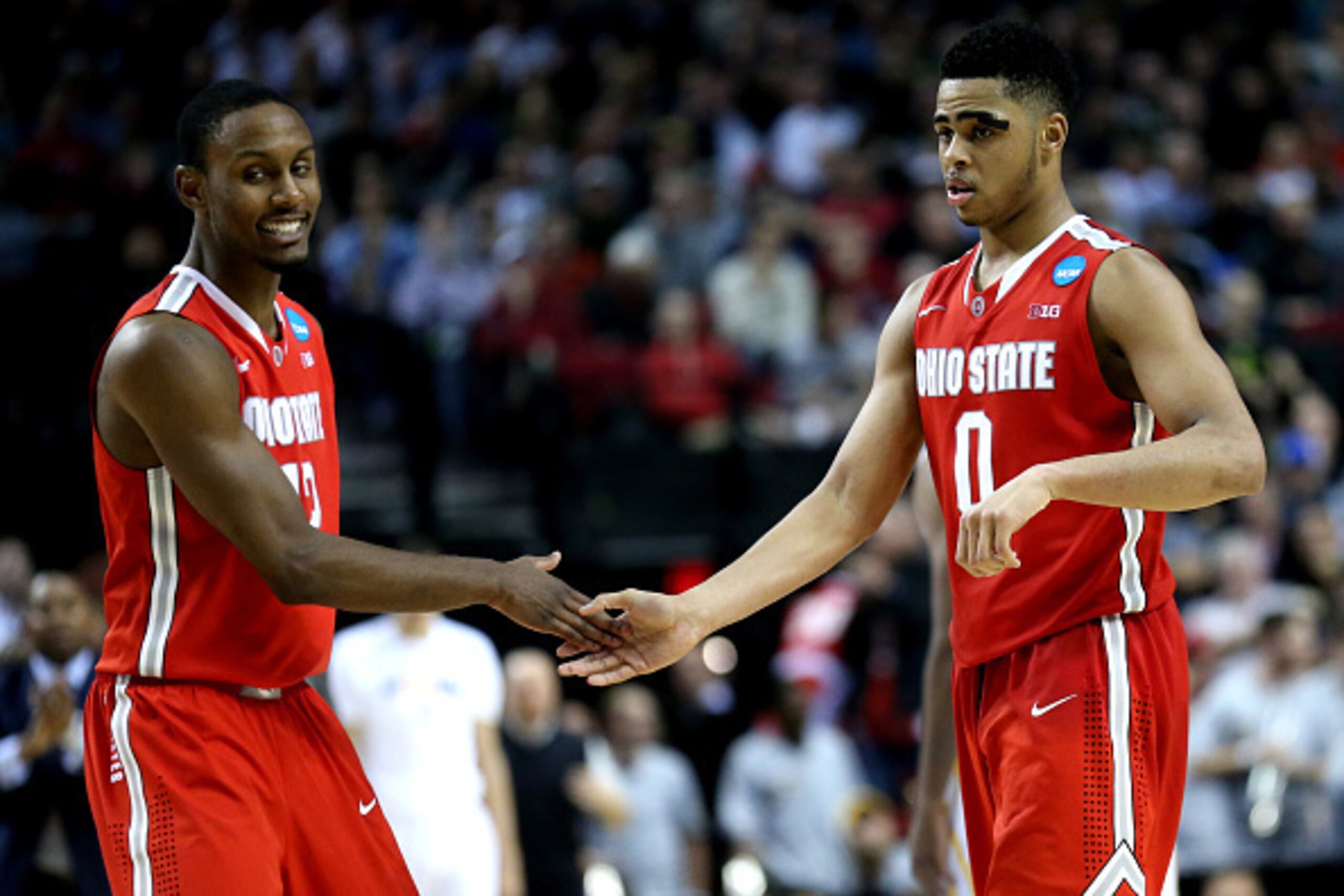 PORTLAND, OR - MARCH 19:  D'Angelo Russell #0 of the Ohio State Buckeyes high-fives Sam Thompson #12 of the Ohio State Buckeyes in overtime against the Virginia Commonwealth Rams during the second round of the 2015 NCAA Men's Basketball Tournament at Moda