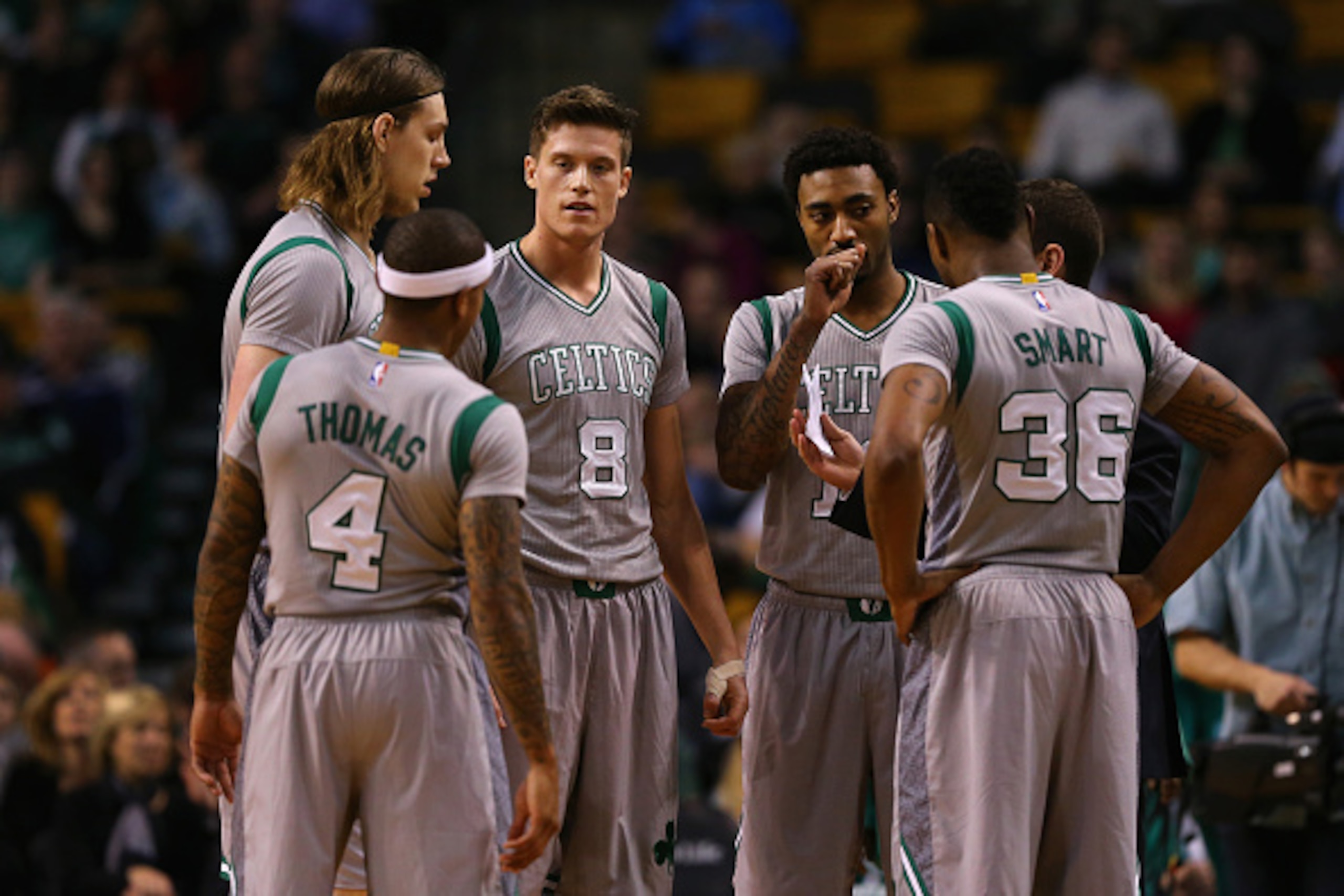 BOSTON, MA - MARCH 04:  Isaiah Thomas #4; Kelly Olynyk #41, Jonas Jerebko #8, James Young #13 and Marcus Smart #36 talk with Brad Stevens of the Boston Celtics during the game against the Utah Jazz at TD Garden on March 4, 2015 in Boston, Massachusetts. N