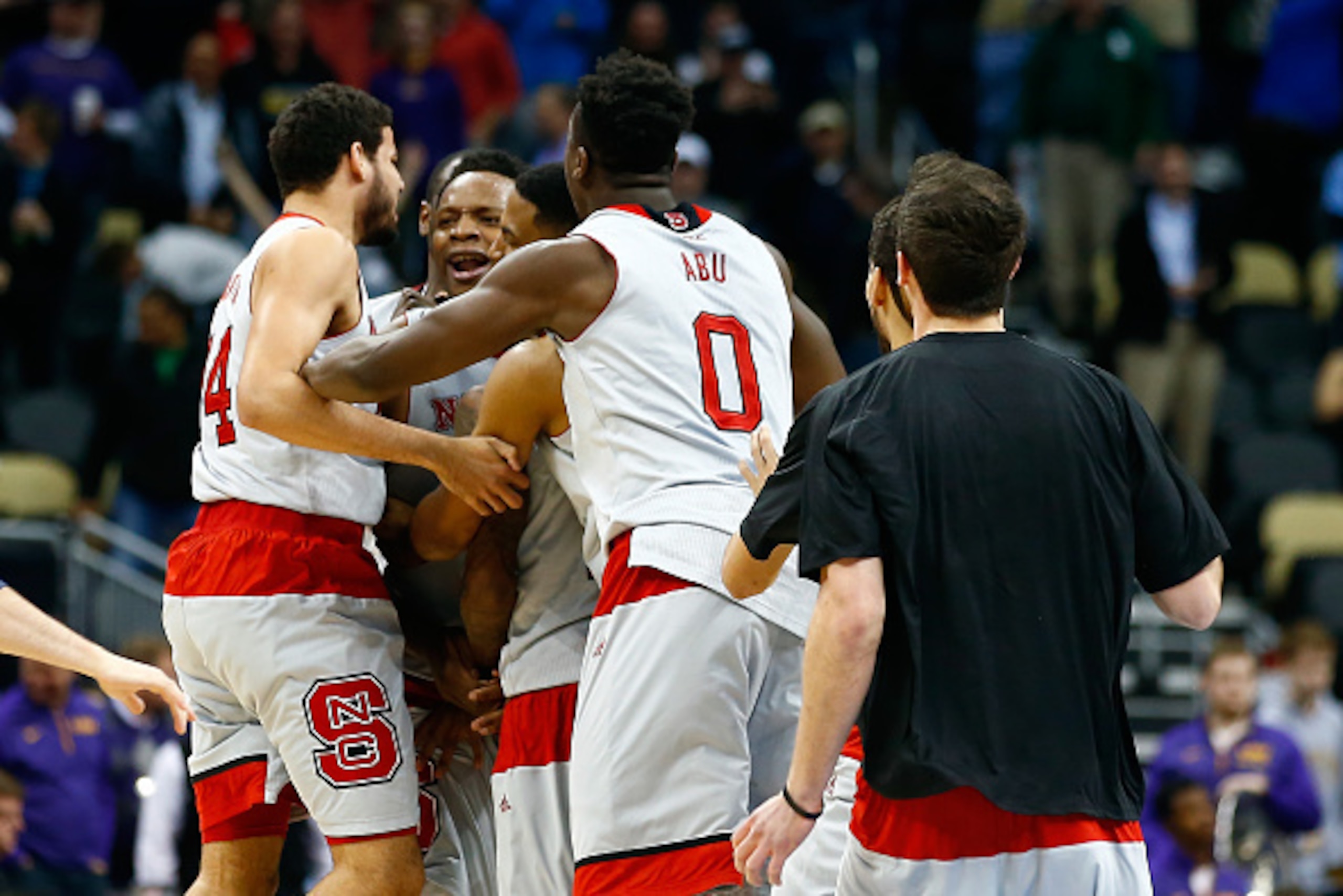 PITTSBURGH, PA - MARCH 19:  Beejay Anya #21 of the North Carolina State Wolfpack celebrates with his teammates after hitting the game winning shot to defeat the LSU Tigers 66 to 65 during the second round of the 2015 NCAA Men's Basketball Tournament at Co