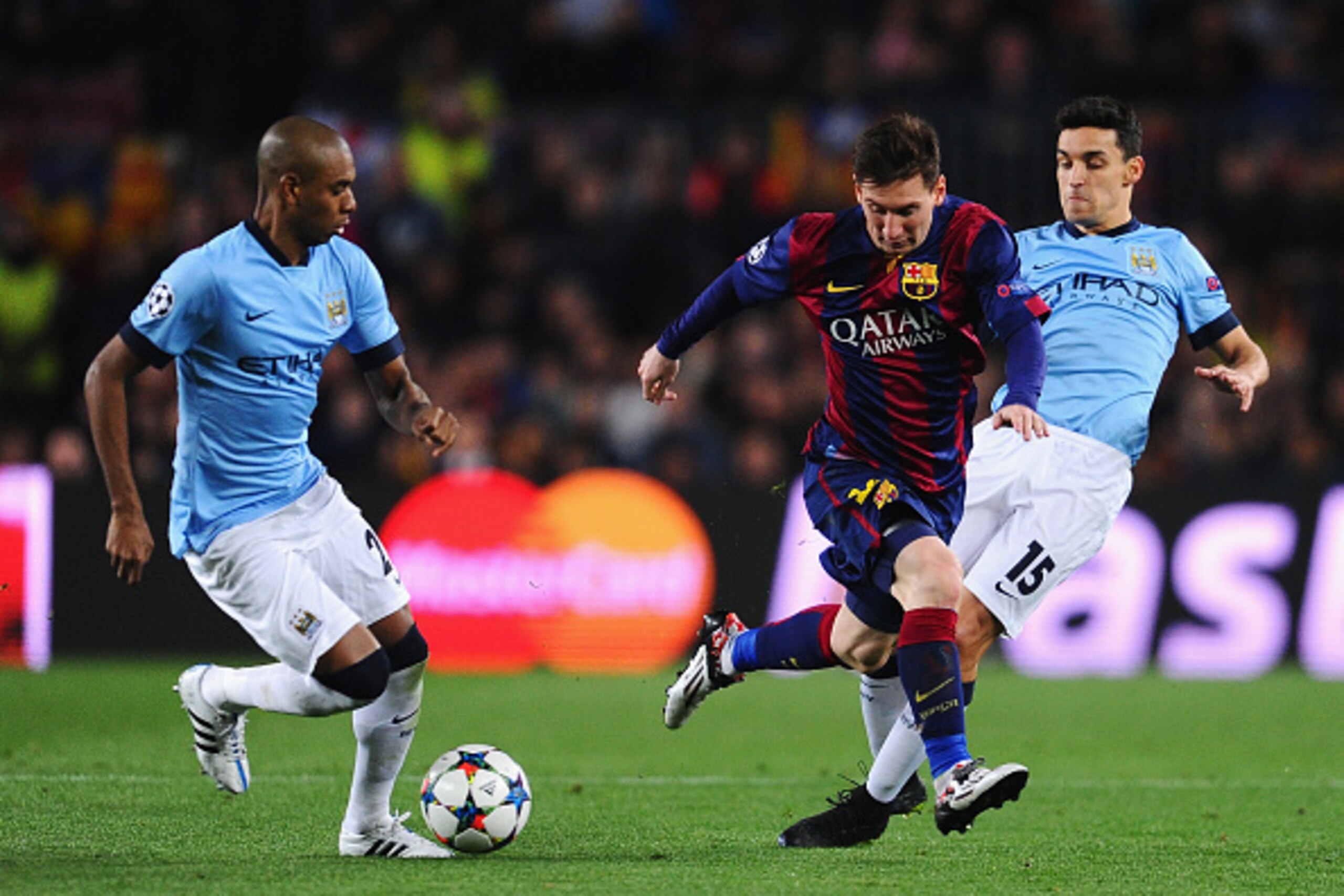 BARCELONA, SPAIN - MARCH 18:  Lionel Messi of Barcelona is challenged by Jesus Navas (R) of Manchester City during the UEFA Champions League Round of 16 second leg match between Barcelona and Manchester City at Camp Nou on March 18, 2015 in Barcelona, Spa
