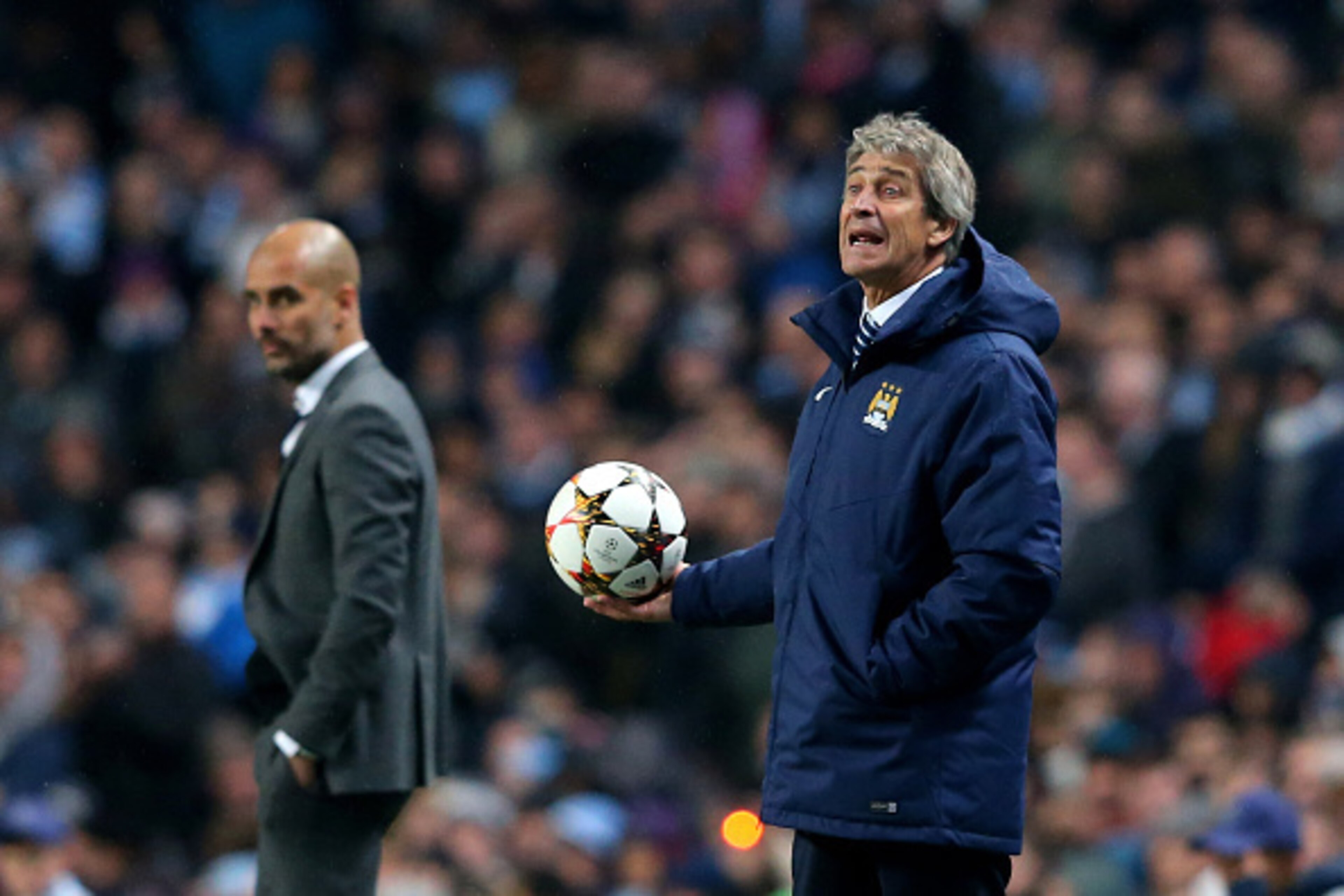 MANCHESTER, ENGLAND - NOVEMBER 25:  (R-L) Manuel Pellegrini the manager of Manchester City reacts as Josep Guardiola the head coach of Bayern Muenchen look on during the UEFA Champions League Group E match between Manchester City and FC Bayern Muenchen at