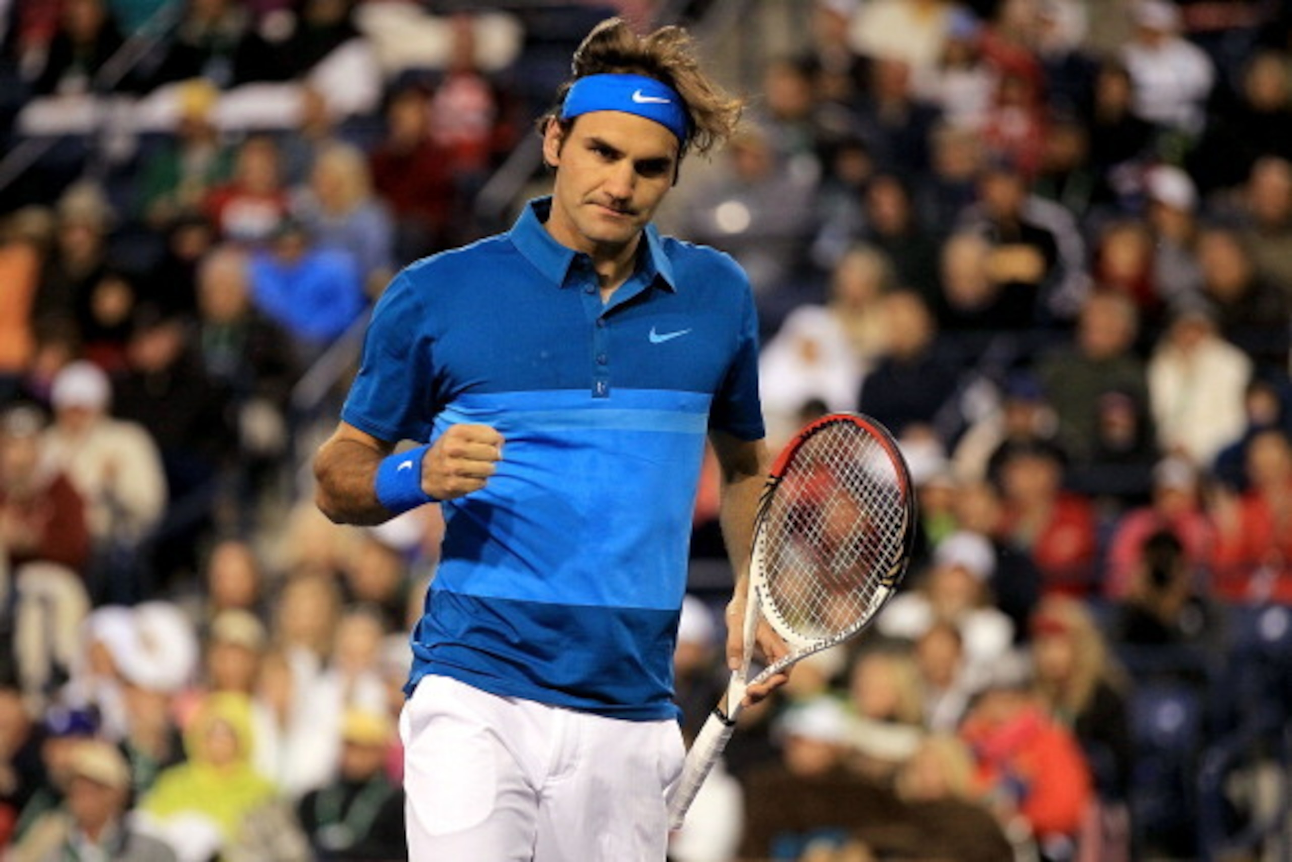 INDIAN WELLS, CA - MARCH 17: Roger Federer of Switzerland celebrates a point against Rafael Nadal of Spain during the semifinals of the BNP Paribas Open at the Indian Wells Tennis Garden on March 17, 2012 in Indian Wells, California.  (Photo by Matthew St