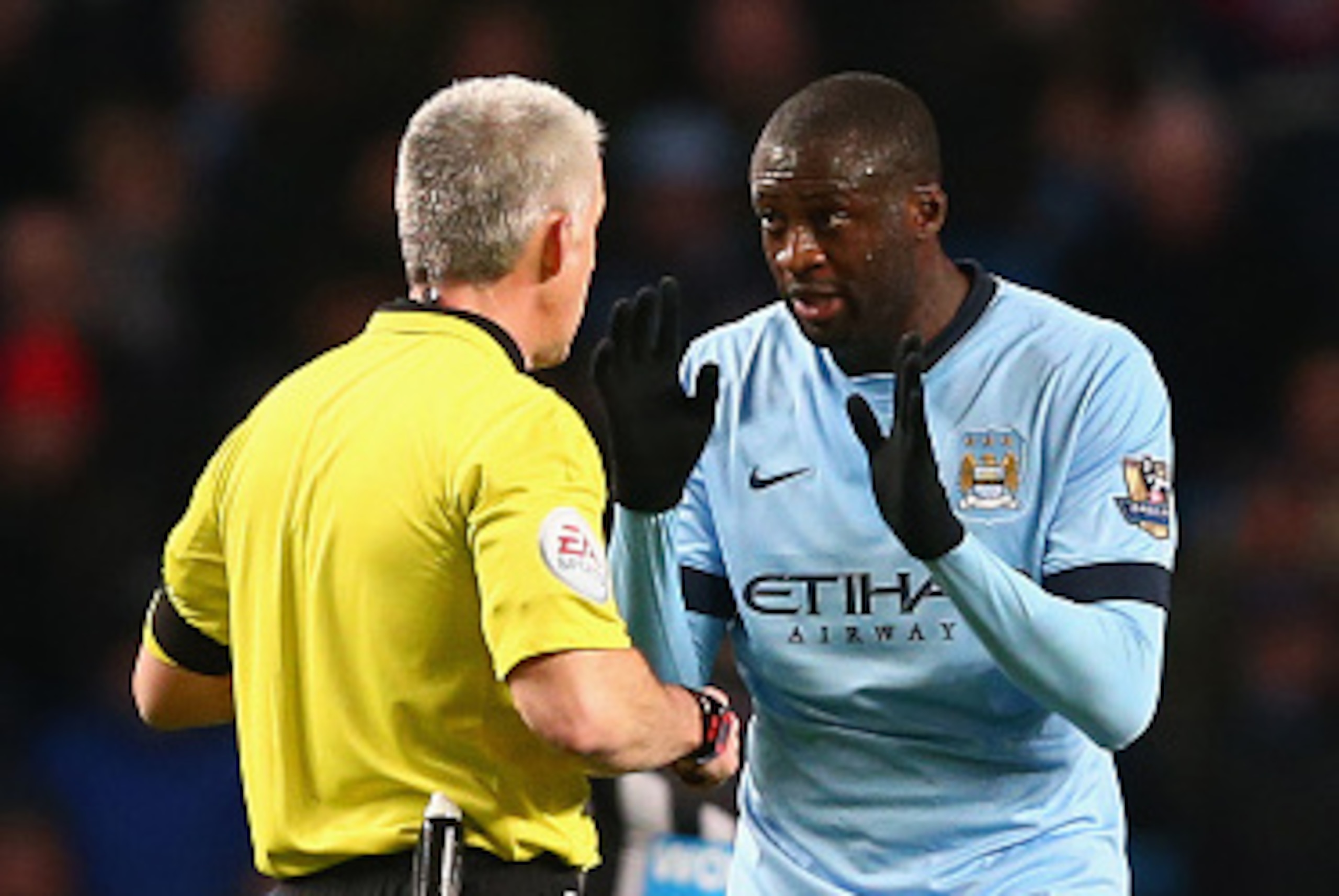 MANCHESTER, ENGLAND - FEBRUARY 21: Yaya Toure of Manchester City speaks to Referee Chris Foy during the Barclays Premier League match between Manchester City and Newcastle United at Etihad Stadium on February 21, 2015 in Manchester, England.  (Photo by Cl