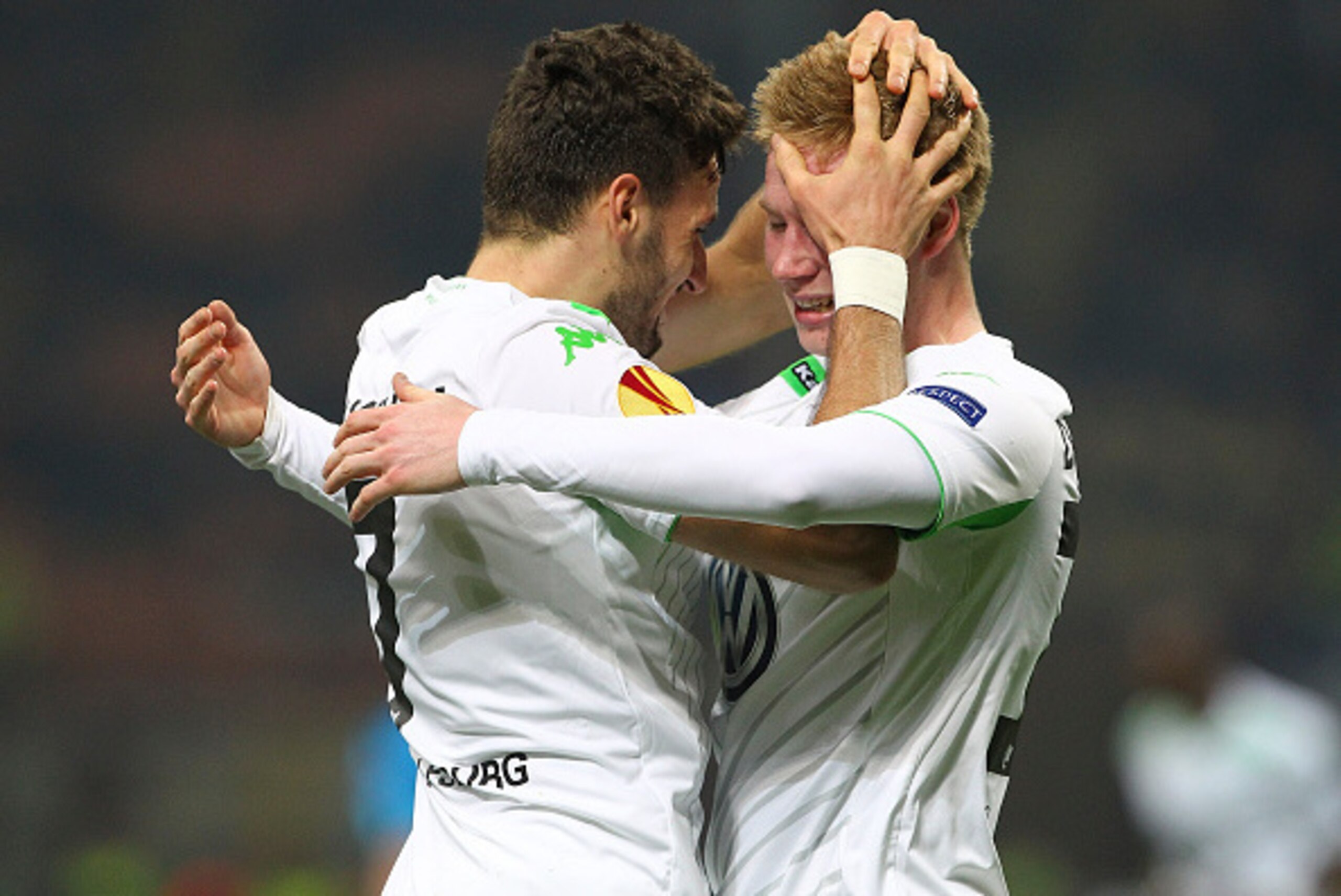 MILAN, ITALY - MARCH 19:  Daniel Caligiuri (L) of VfL Wolfsburg celebrates with his teammate Kevin De Bruyne after scoring the opening goal during the UEFA Europa League Round of 16 match between FC Internazionale Milano and VfL Wolfsburg at Stadio Giusep