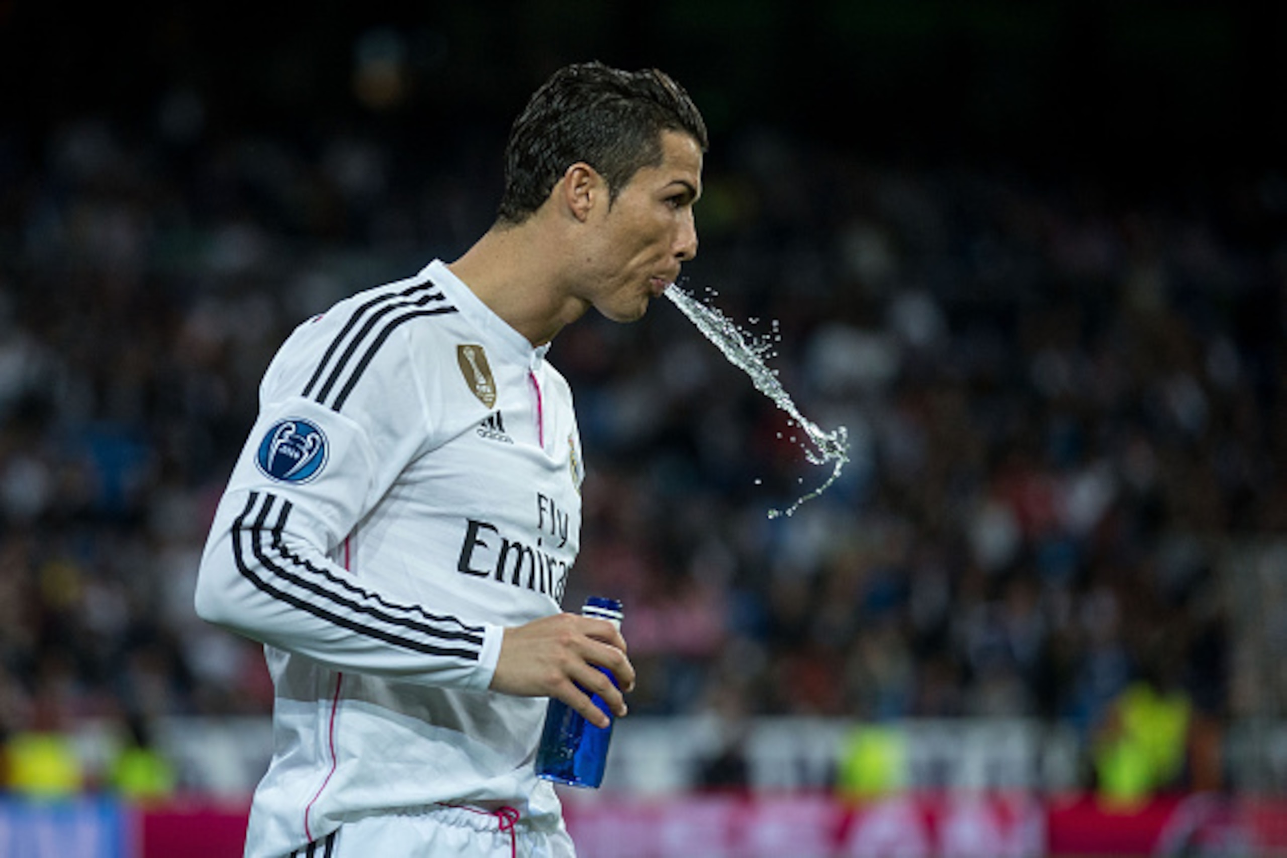 MADRID, SPAIN - MARCH 10: Cristiano Ronaldo of Real Madrid CF spits water prior to start  the UEFA Champions League round of 16 second leg match between Real Madrid CF and FC Schalke 04 at Estadio Santiago Bernabeu on March 10, 2015 in Madrid, Spain.  (Ph