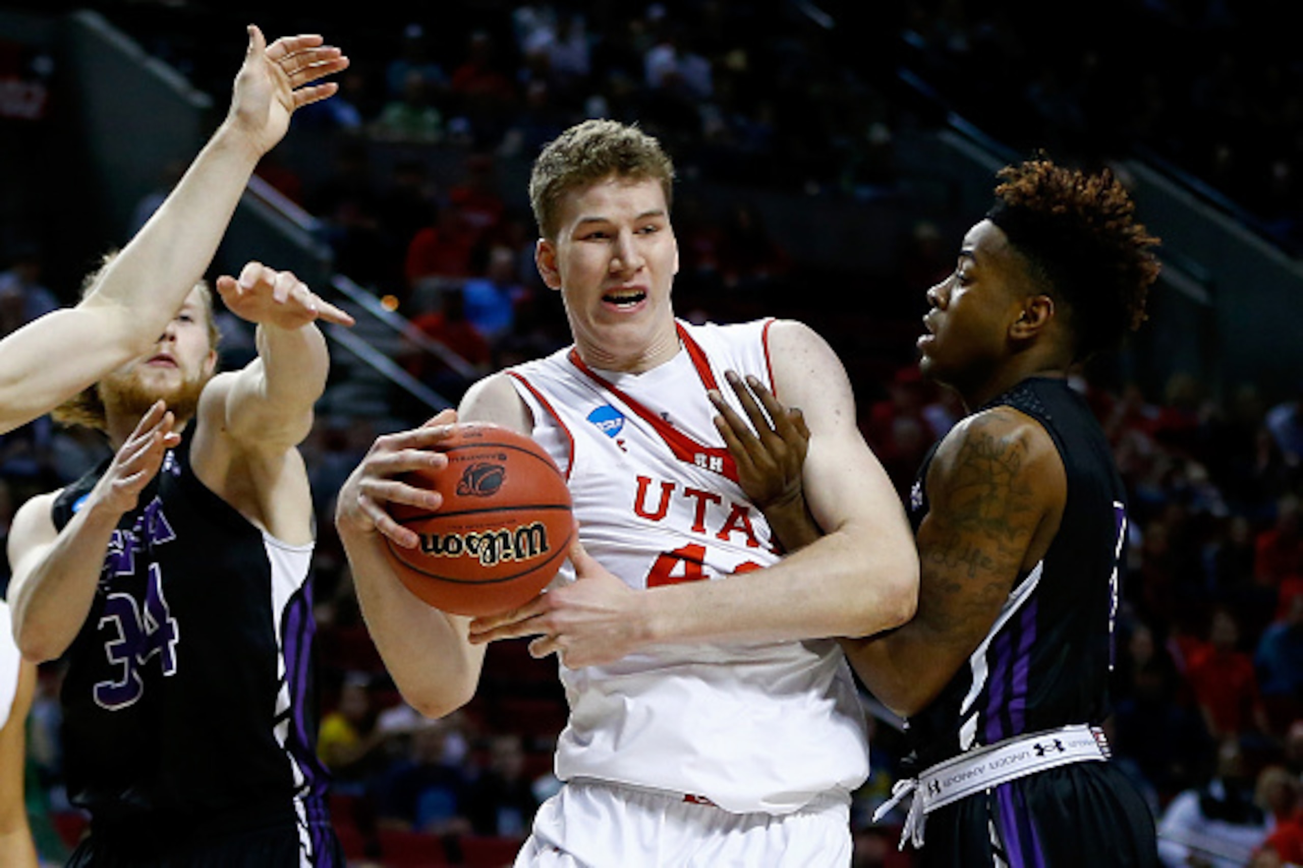 PORTLAND, OR - MARCH 19: Jakob Poeltl #42 of the Utah Utes controls the ball against Ty Charles #4 of the Stephen F. Austin Lumberjacks in the first half during the second round of the 2015 NCAA Men's Basketball Tournament at Moda Center on March 19, 2015