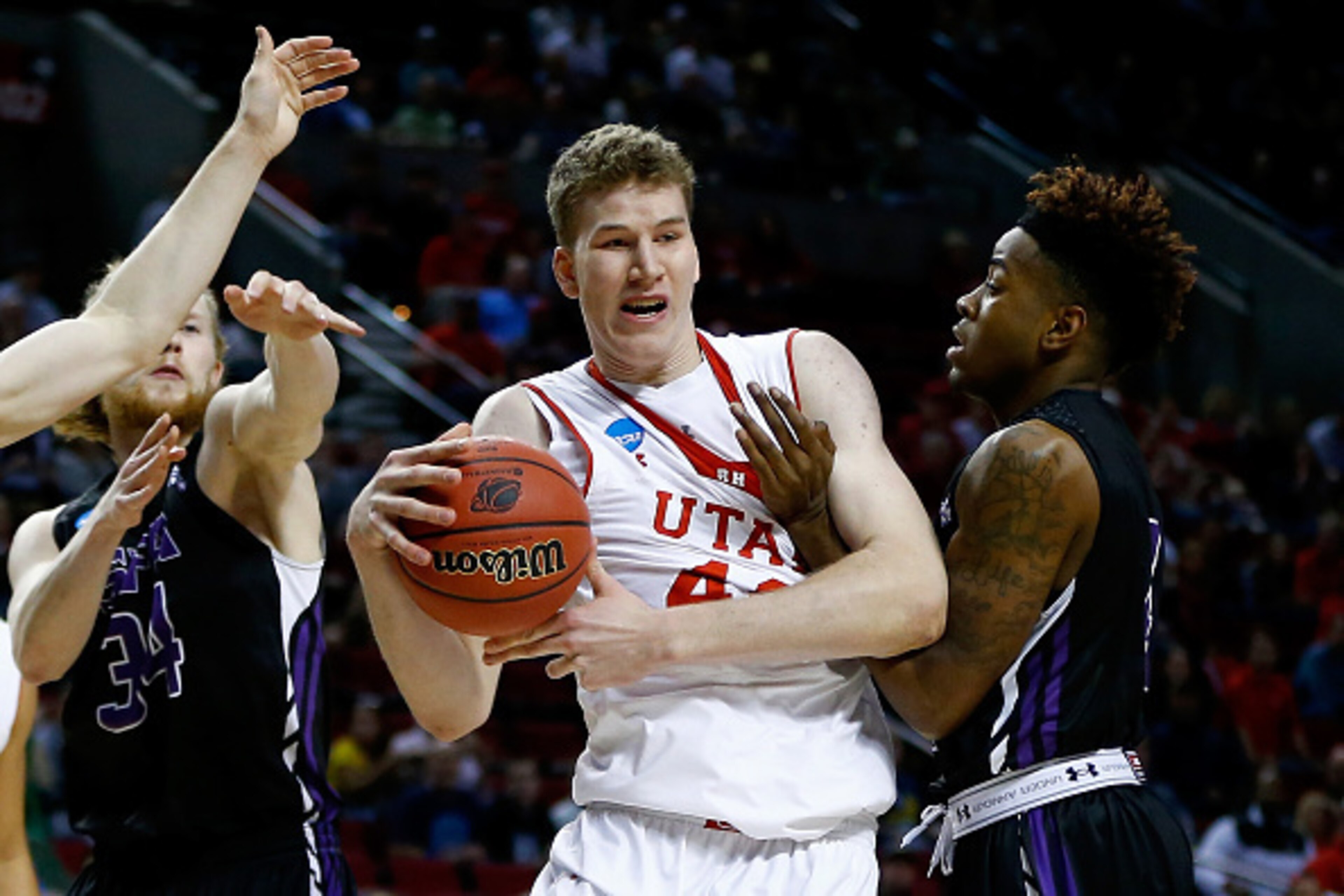 PORTLAND, OR - MARCH 19: Jakob Poeltl #42 of the Utah Utes controls the ball against Ty Charles #4 of the Stephen F. Austin Lumberjacks in the first half during the second round of the 2015 NCAA Men's Basketball Tournament at Moda Center on March 19, 2015