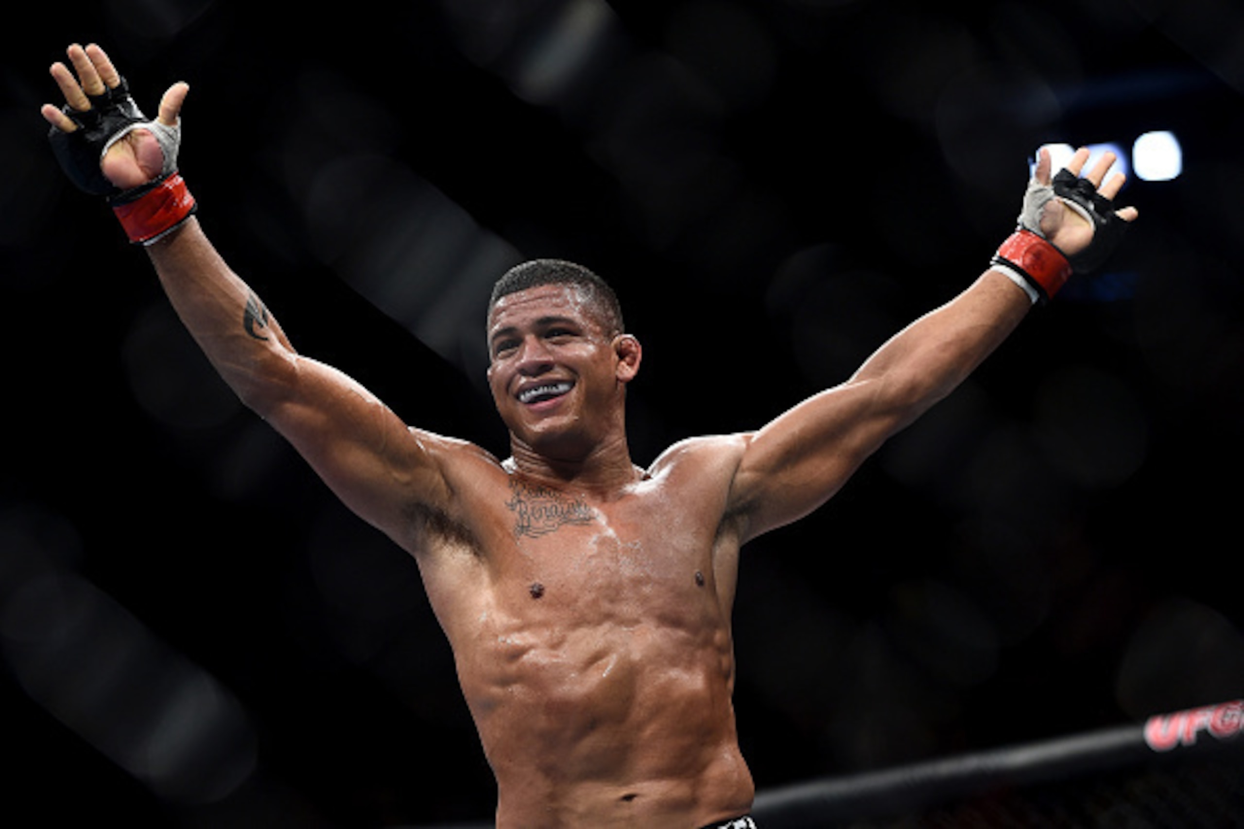 RIO DE JANEIRO, BRAZIL - OCTOBER 25:  Gilbert Burns of Brazil celebrates after his submission victory over Christos Giagos in their lightweight bout during the UFC 179 event at Maracanazinho on October 25, 2014 in Rio de Janeiro, Brazil.  (Photo by Buda M