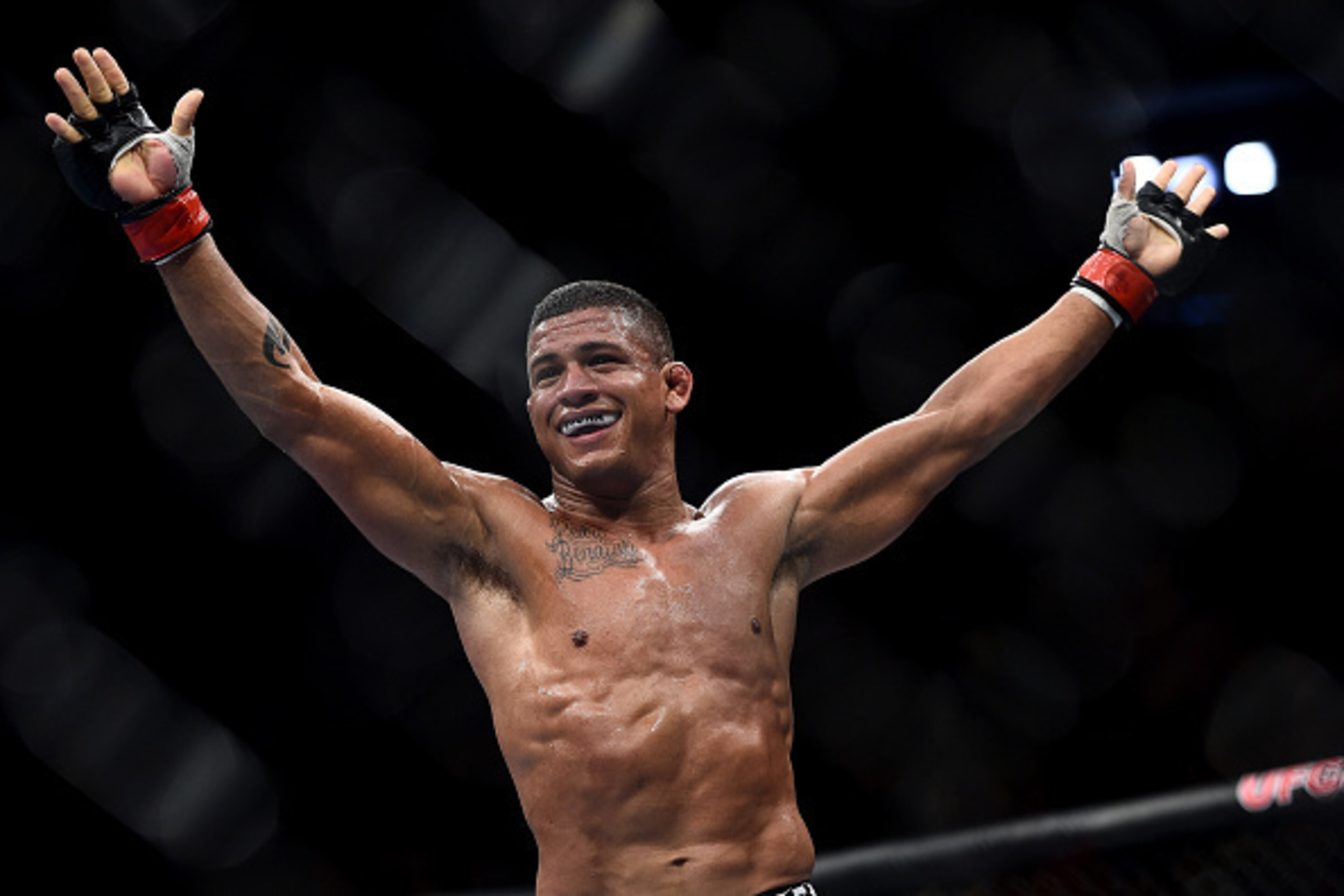 RIO DE JANEIRO, BRAZIL - OCTOBER 25:  Gilbert Burns of Brazil celebrates after his submission victory over Christos Giagos in their lightweight bout during the UFC 179 event at Maracanazinho on October 25, 2014 in Rio de Janeiro, Brazil.  (Photo by Buda M