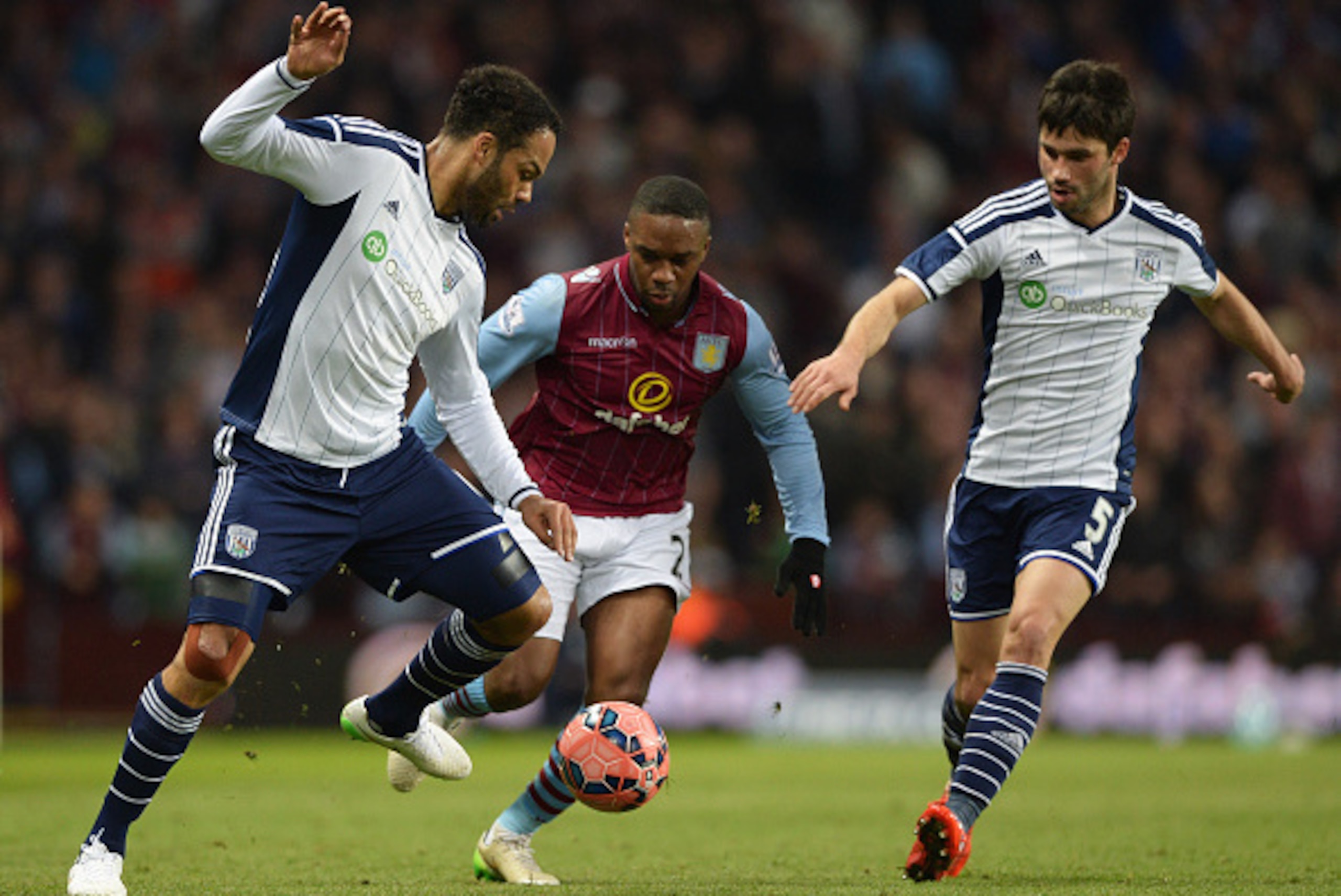 BIRMINGHAM, ENGLAND - MARCH 07:  Charles N'Zogbia of Aston Villa is foiled by Joleon Lescott (L) and Claudio Yacob of West Bromwich Albion (R) during the FA Cup Quarter Final match between Aston Villa and West Bromwich Albion at Villa Park on March 7, 201