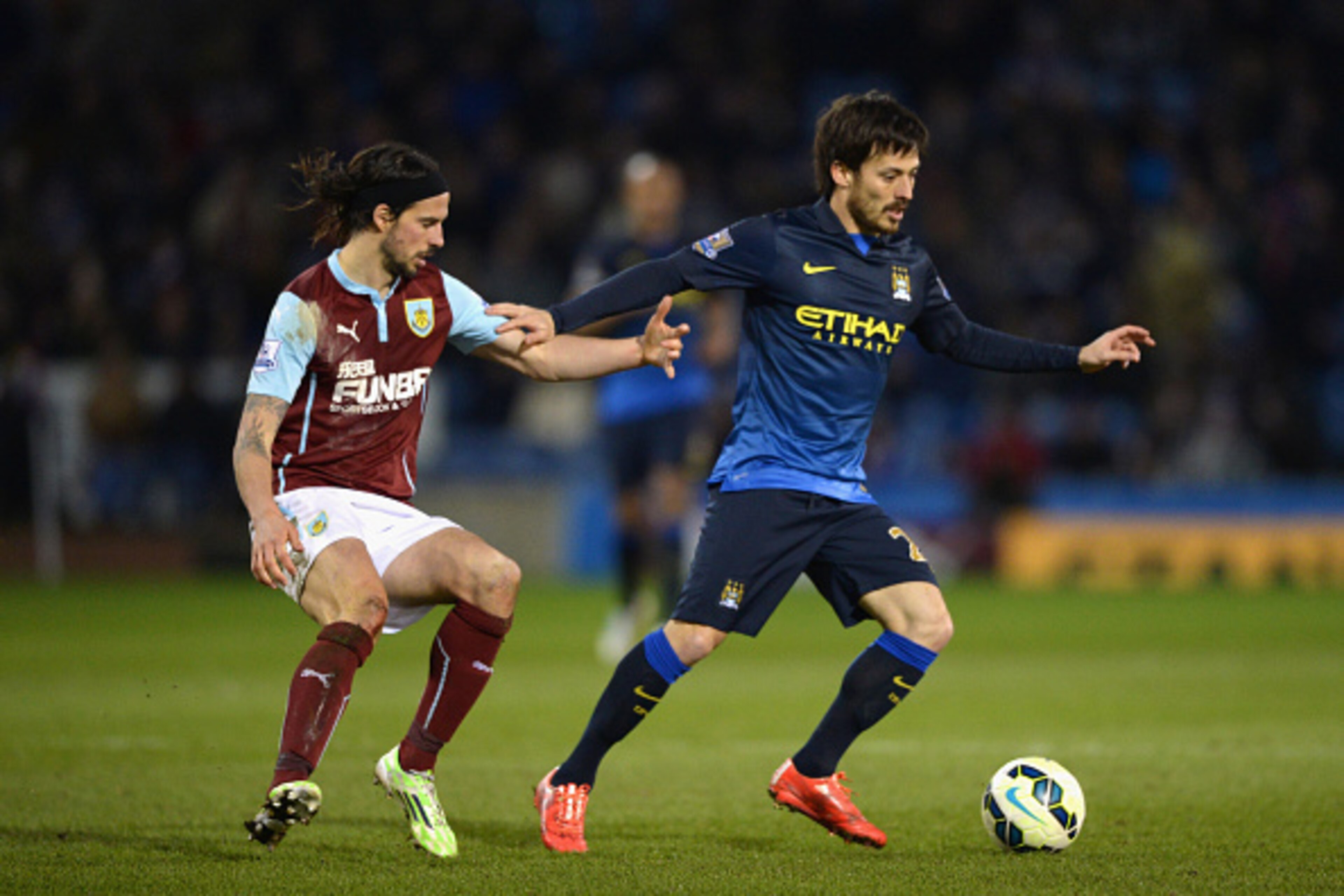 BURNLEY, ENGLAND - MARCH 14:  George Boyd of Burnley marks David Silva of Manchester City during the Barclays Premier League match between Burnley and Manchester City at Turf Moor on March 14, 2015 in Burnley, England.  (Photo by Gareth Copley/Getty Image