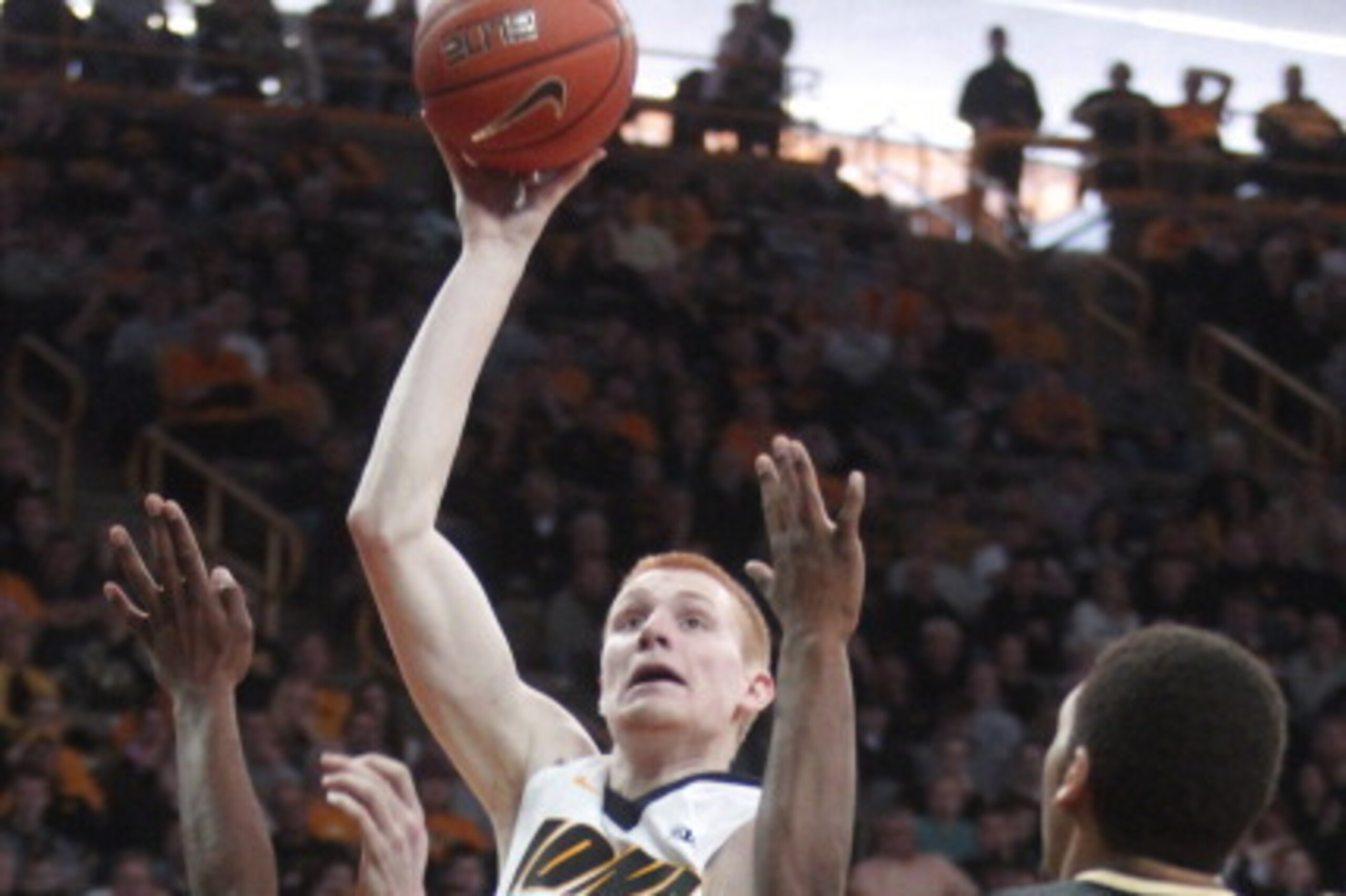 IOWA CITY, IA - MARCH 2: Forward Aaron White #30 of the Iowa Hawkeyes takes a shot during the second half in front of forward Errick Peck #32 of the Purdue Boilermakers on March 2, 2014 at Carver-Hawkeye Arena, in Iowa City, Iowa. Iowa won 83-76. (Photo IOWA CITY, IA - MARCH 2: Forward Aaron White #30 of the Iowa Hawkeyes takes a shot during the second half in front of forward Errick Peck #32 of the Purdue Boilermakers on March 2, 2014 at Carver-Hawkeye Arena, in Iowa City, Iowa. Iowa won 83-76. (Photo