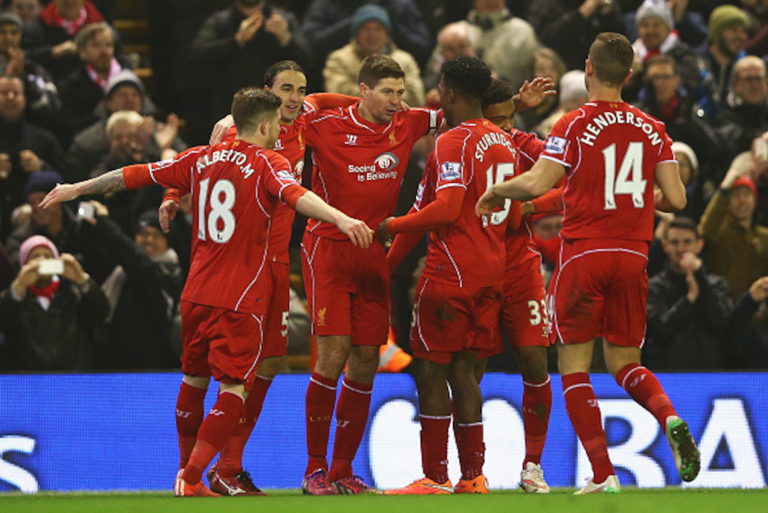 LIVERPOOL, ENGLAND - FEBRUARY 10:  Steven Gerrard of Liverpool celebrates scoring his penalty with team mates during the Barclays Premier League match between Liverpool and Tottenham Hotspur at Anfield on February 10, 2015 in Liverpool, England.  (Photo b