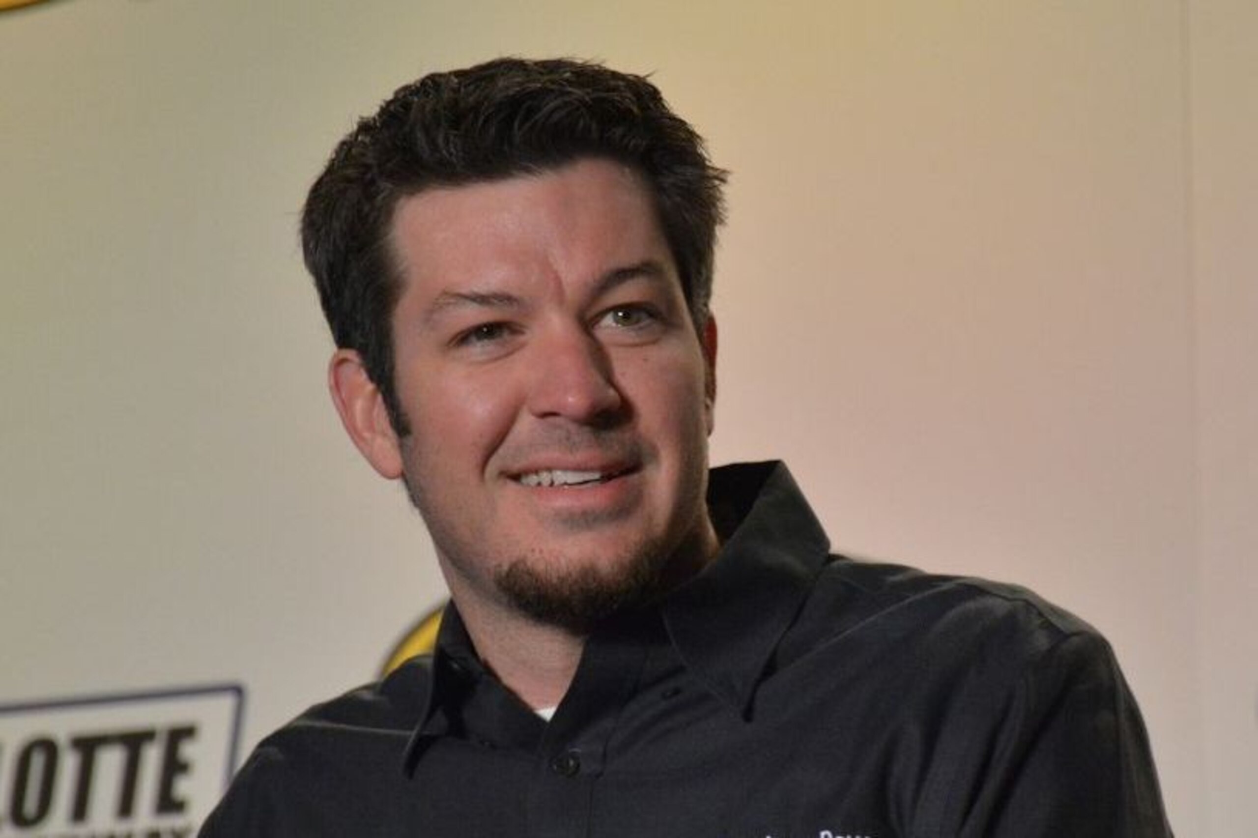 Martin Truex Jr. on stage for media at Charlotte before the 2015 season.