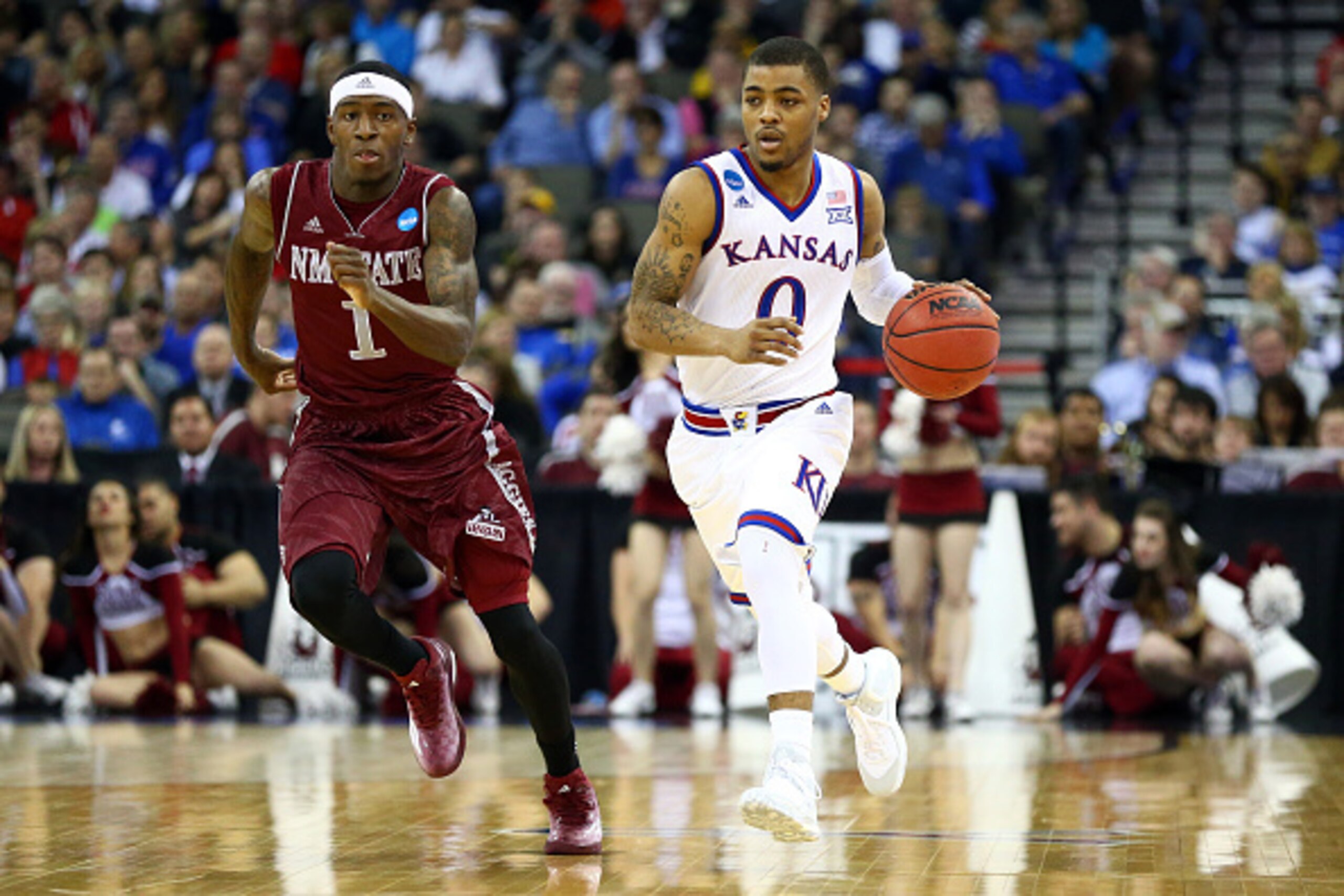 OMAHA, NE - MARCH 20: Frank Mason III #0 of the Kansas Jayhawks brings the ball up the floor against DK Eldridge #1 of the New Mexico State Aggies during the second round of the 2015 NCAA Men's Basketball Tournament at the CenturyLink Center on March 20, 