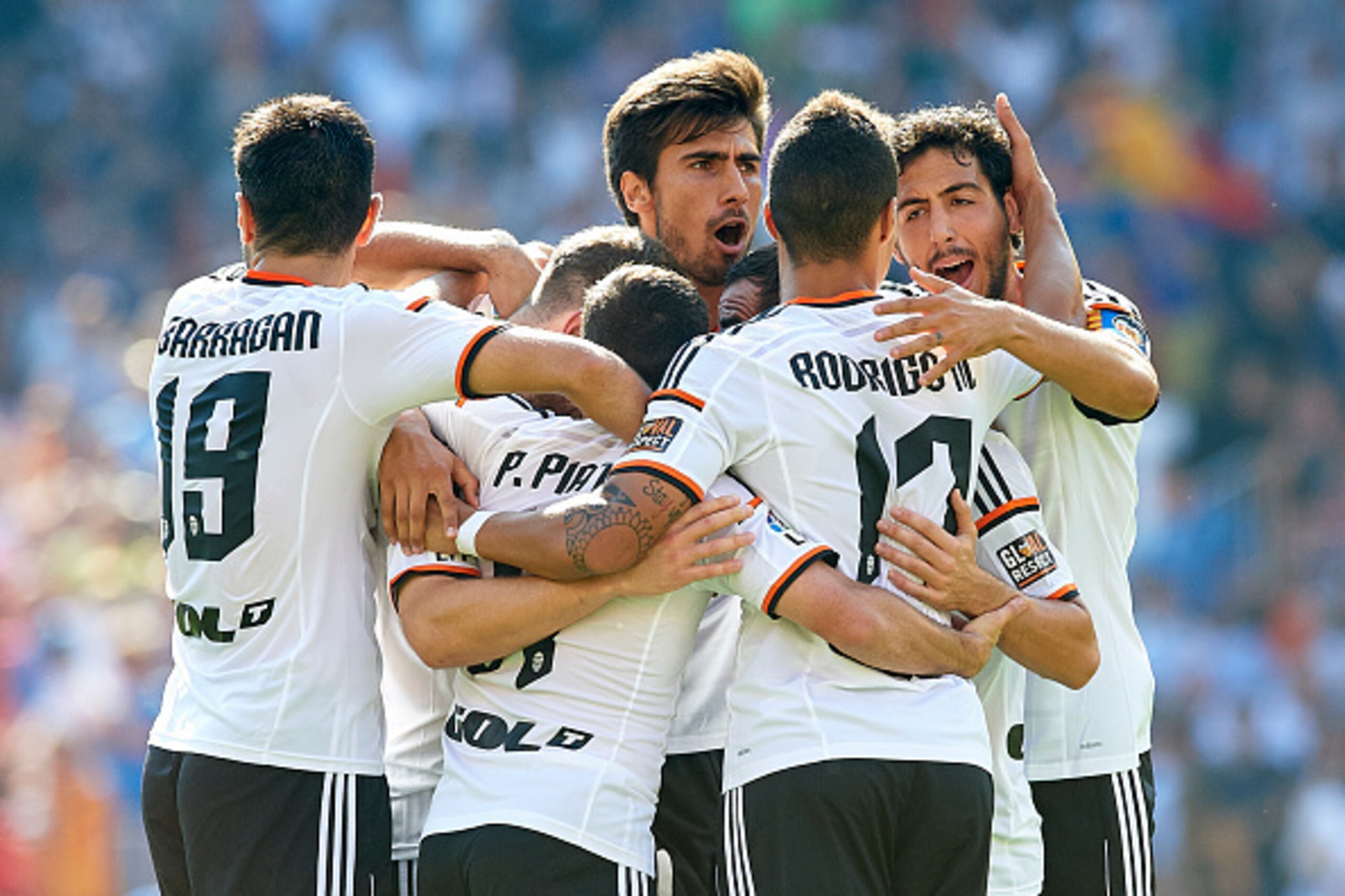 VALENCIA, SPAIN - OCTOBER 04: Players of Valencia celebrate the first goal during the La Liga match between Valencia CF and Club Atletico de Madrid at Estadi de Mestalla on October 4, 2014 in Valencia, Spain.  (Photo by Manuel Queimadelos Alonso/Getty Ima