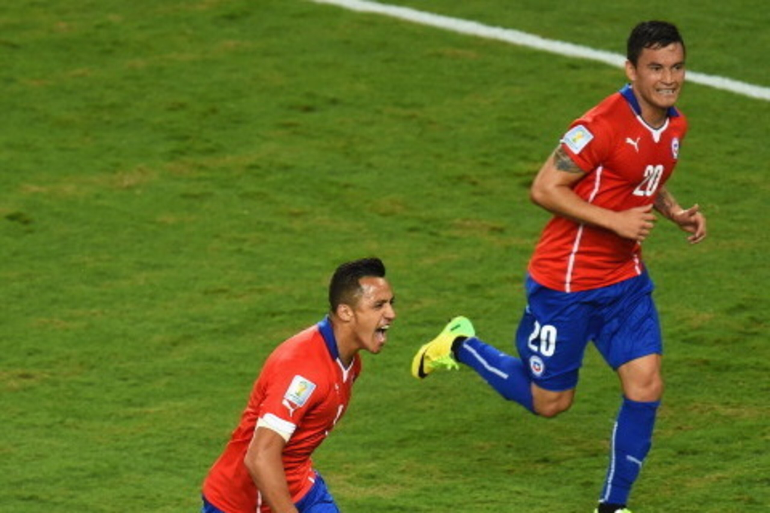 CUIABA, BRAZIL - JUNE 13:  Alexis Sanchez of Chile (L) celebrates scoring the team's first goal with Charles Aranguiz during the 2014 FIFA World Cup Brazil Group B match between Chile and Australia at Arena Pantanal on June 13, 2014 in Cuiaba, Brazil.  (P