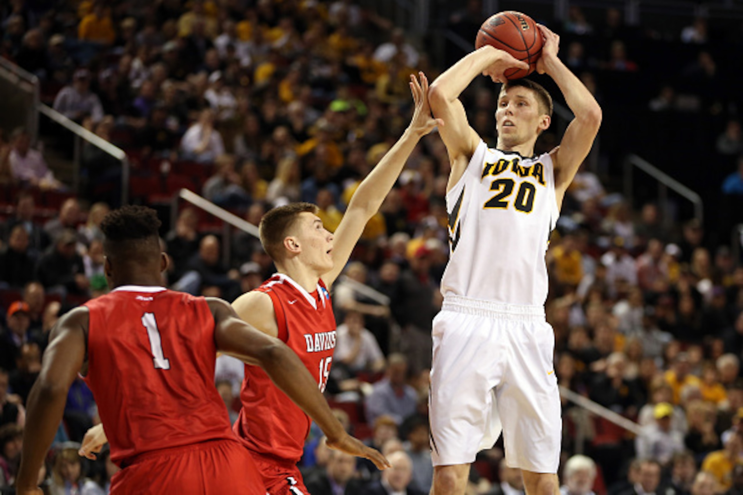SEATTLE, WA - MARCH 20:  Jarrod Uthoff #20 of the Iowa Hawkeyes shoots the ball against Oskar Michelsen #15 and Youssef Mejri #1 of the Davidson Wildcats in the first half of the game during the second round of the 2015 NCAA Men's Basketball Tournament at