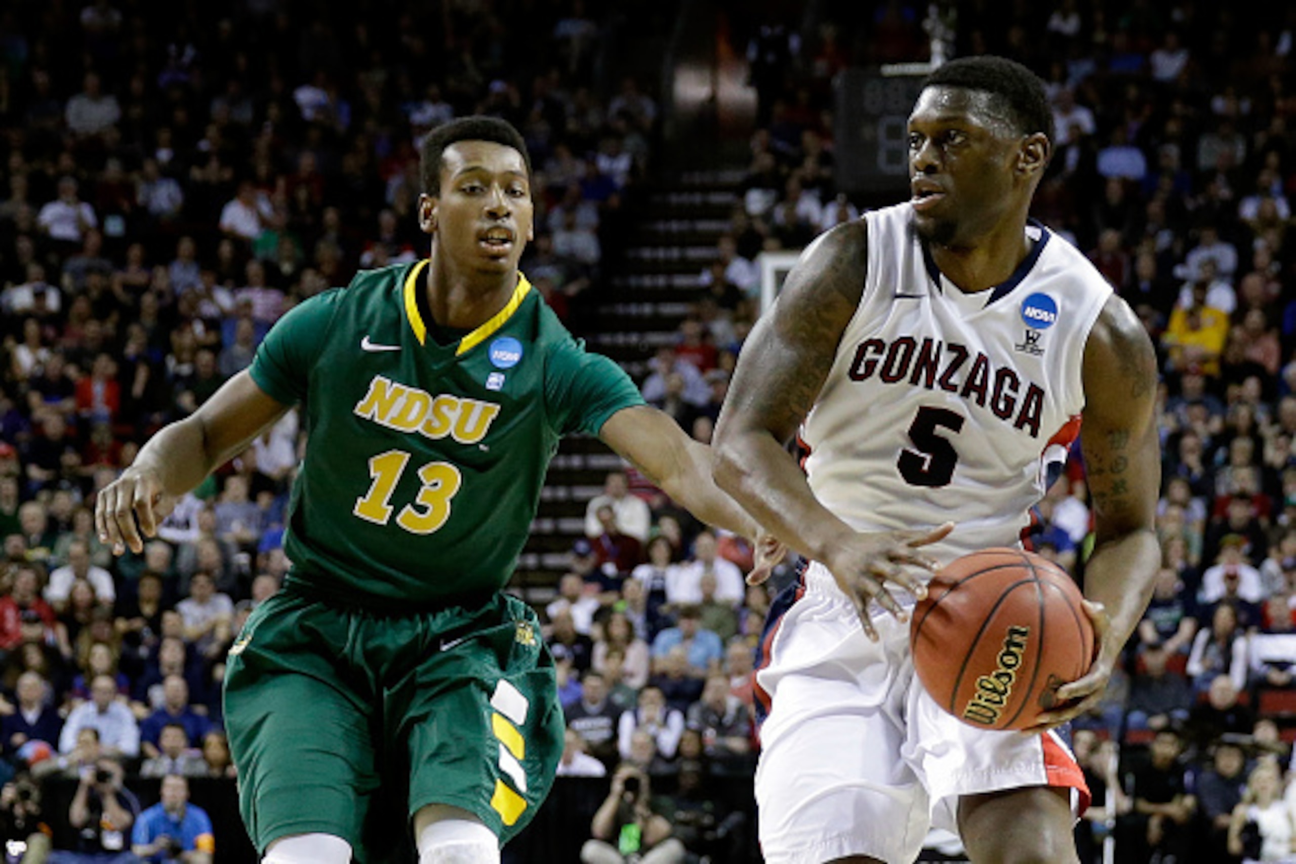 SEATTLE, WA - MARCH 20:  Gary Bell Jr. #5 of the Gonzaga Bulldogs dribbles the ball against Carlin Dupree #13 of the North Dakota State Bison in the first half of the game during the second round of the 2015 NCAA Men's Basketball Tournament at KeyArena on