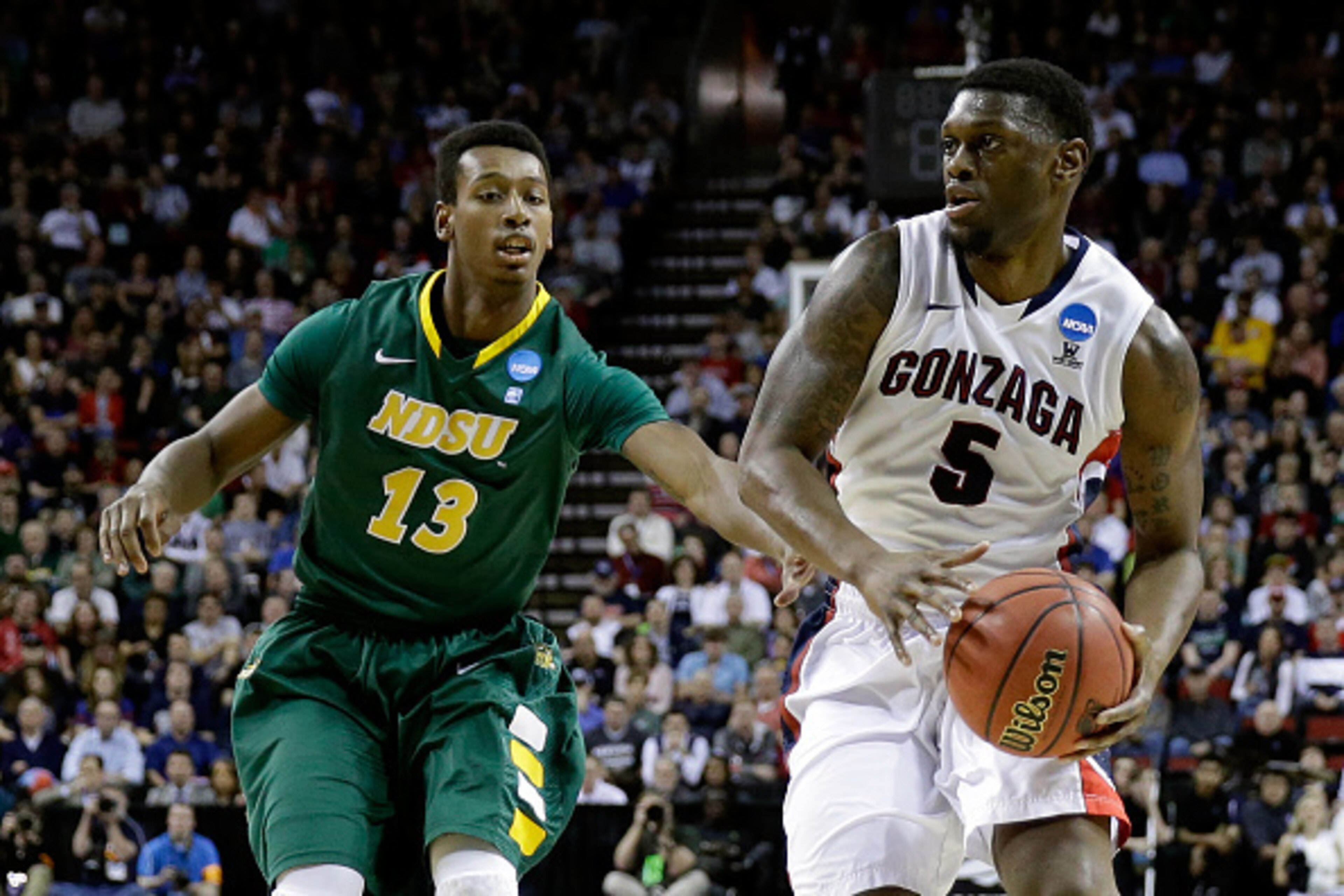 SEATTLE, WA - MARCH 20: Gary Bell Jr. #5 of the Gonzaga Bulldogs dribbles the ball against Carlin Dupree #13 of the North Dakota State Bison in the first half of the game during the second round of the 2015 NCAA Men's Basketball Tournament at KeyArena on SEATTLE, WA - MARCH 20: Gary Bell Jr. #5 of the Gonzaga Bulldogs dribbles the ball against Carlin Dupree #13 of the North Dakota State Bison in the first half of the game during the second round of the 2015 NCAA Men's Basketball Tournament at KeyArena on