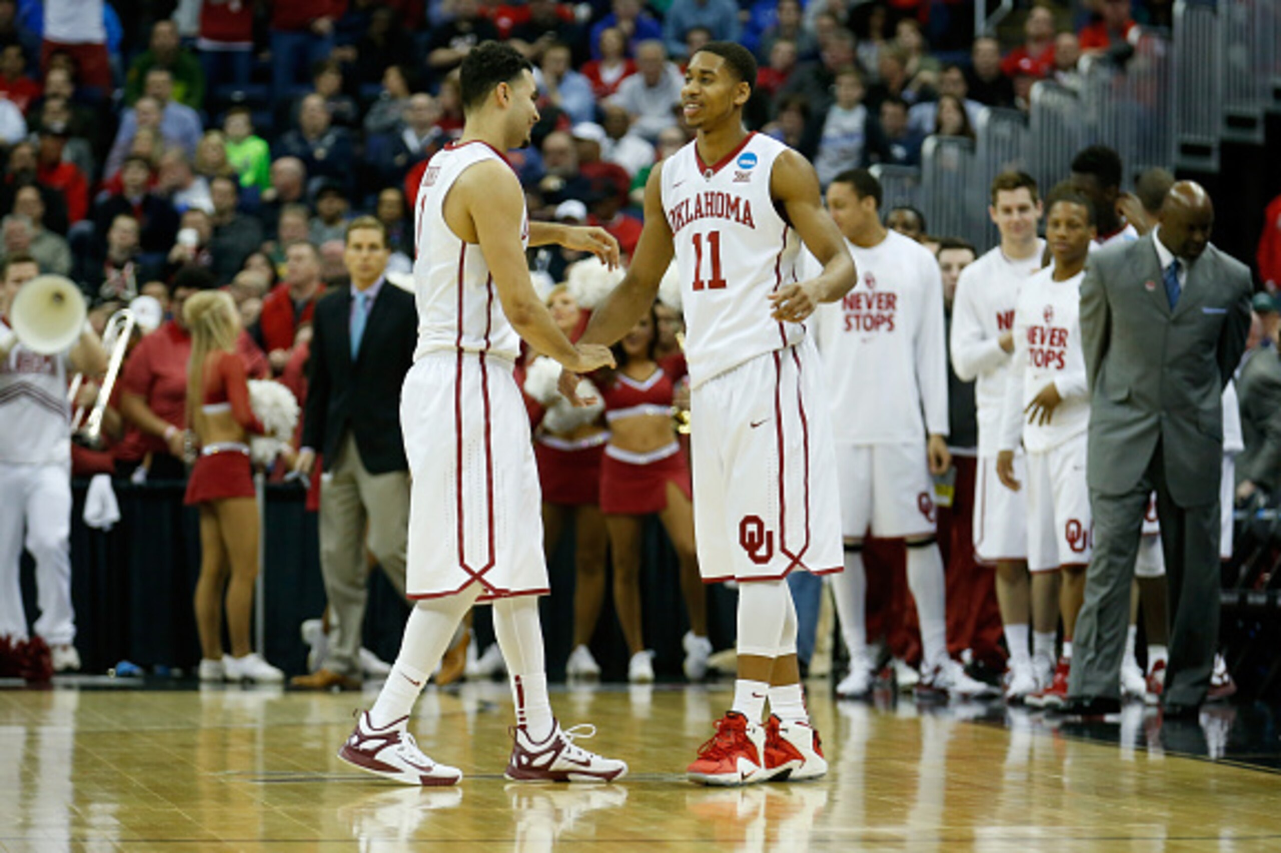 COLUMBUS, OH - MARCH 20: Frank Booker #1 (L) and Isaiah Cousins #11 of the Oklahoma Sooners celebrate following the Sooners 69-60 win over the Albany Great Danes during the second round of the 2015 NCAA Men's Basketball Tournament at Nationwide Arena on M