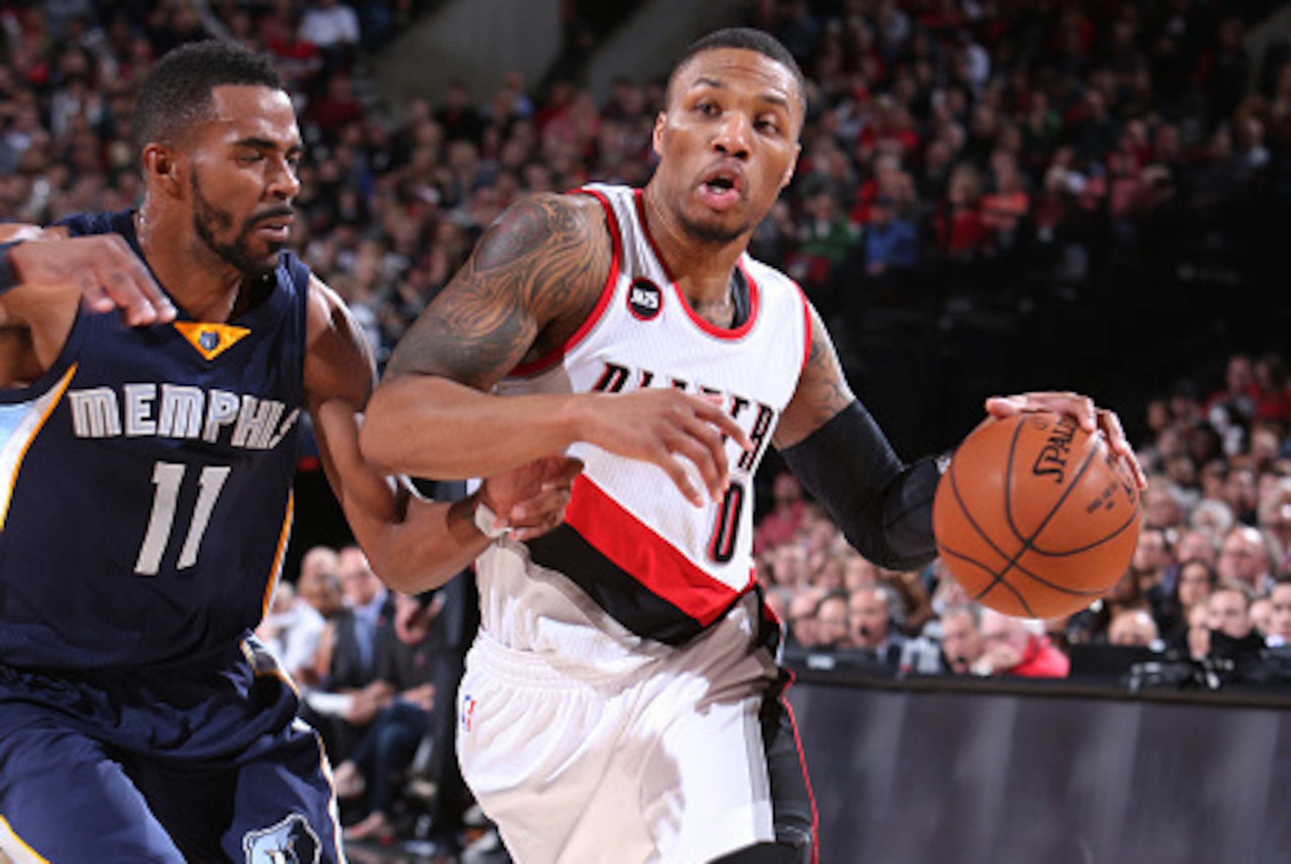 PORTLAND, OR - FEBRUARY 22:  Damian Lillard #0 of the Portland Trail Blazers drives to the basket against the Memphis Grizzlies on February 22, 2015 at the Moda Center Arena in Portland, Oregon. NOTE TO USER: User expressly acknowledges and agrees that, b