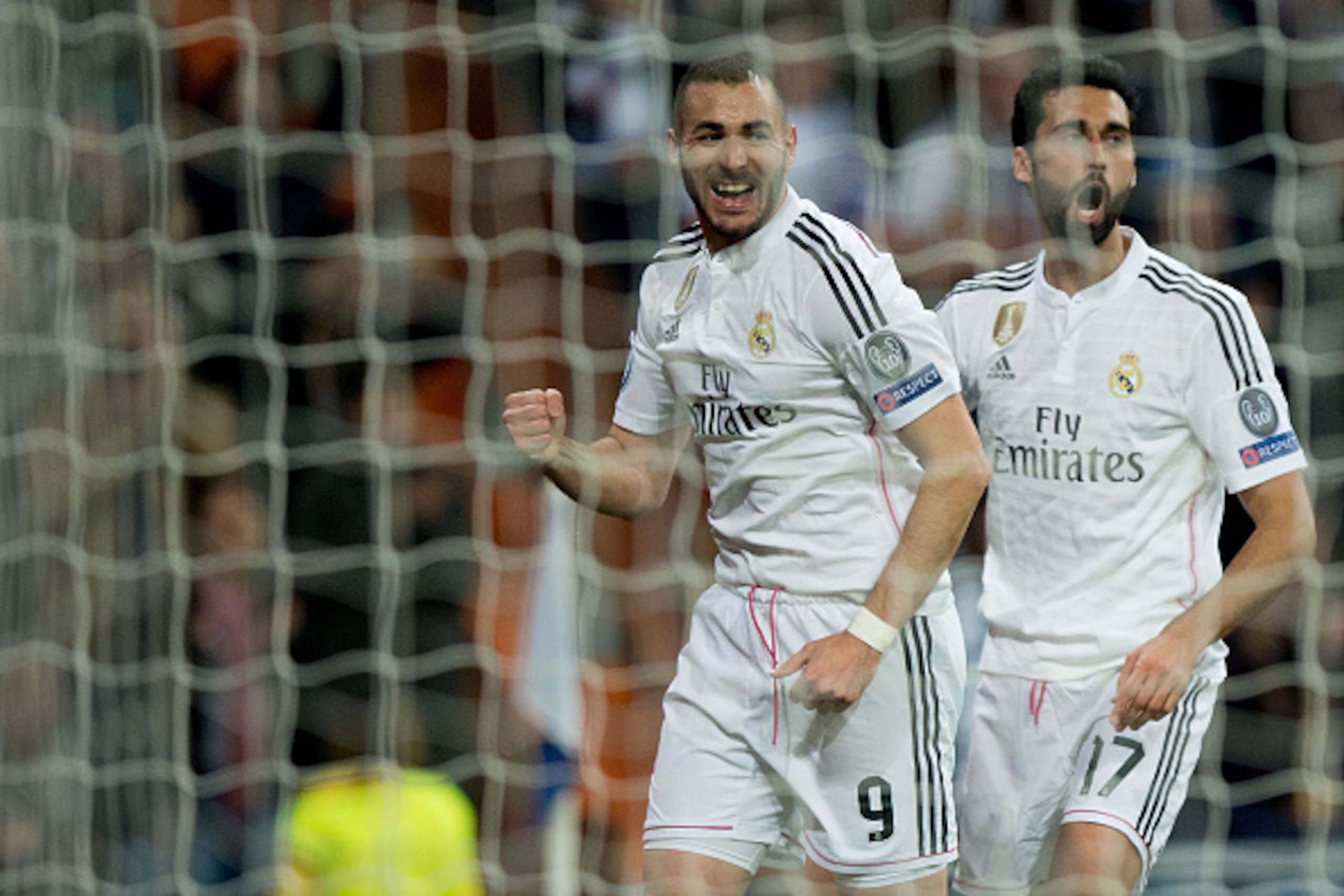 MADRID, SPAIN - MARCH 10:  Karim Benzema (L) of Real Madrid CF celebrates scoring their third goal with teammate Alvaro Arbeloa (R) during the UEFA Champions League round of 16 second leg match between Real Madrid CF and FC Schalke 04 at Estadio Santiago 