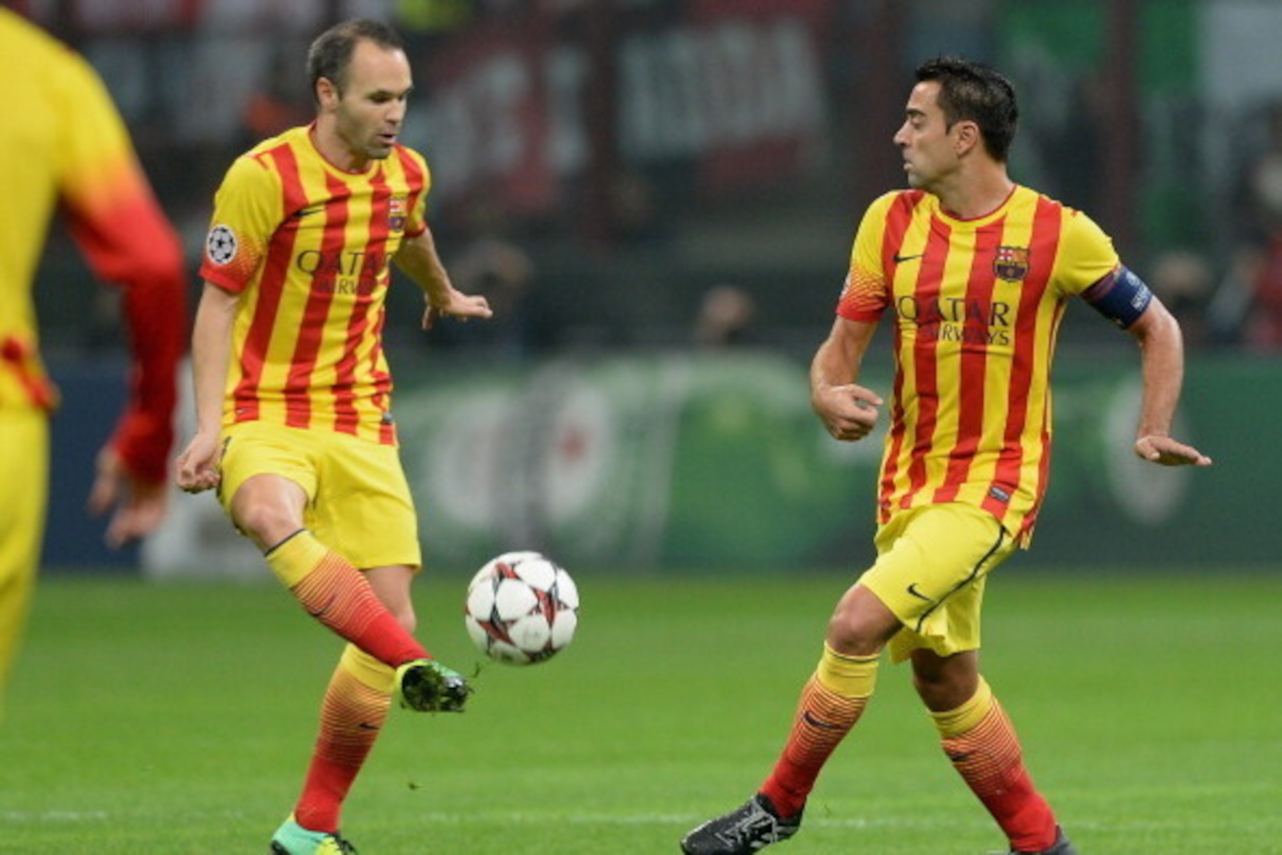 MILAN, ITALY - OCTOBER 22:  Xavi Hernandez and Andres Iniesta of FC Barcelona (L) during the UEFA Champions League Group H match between AC Milan and Barcelona at Stadio Giuseppe Meazza on October 22, 2013 in Milan, Italy.  (Photo by Claudio Villa/Getty I