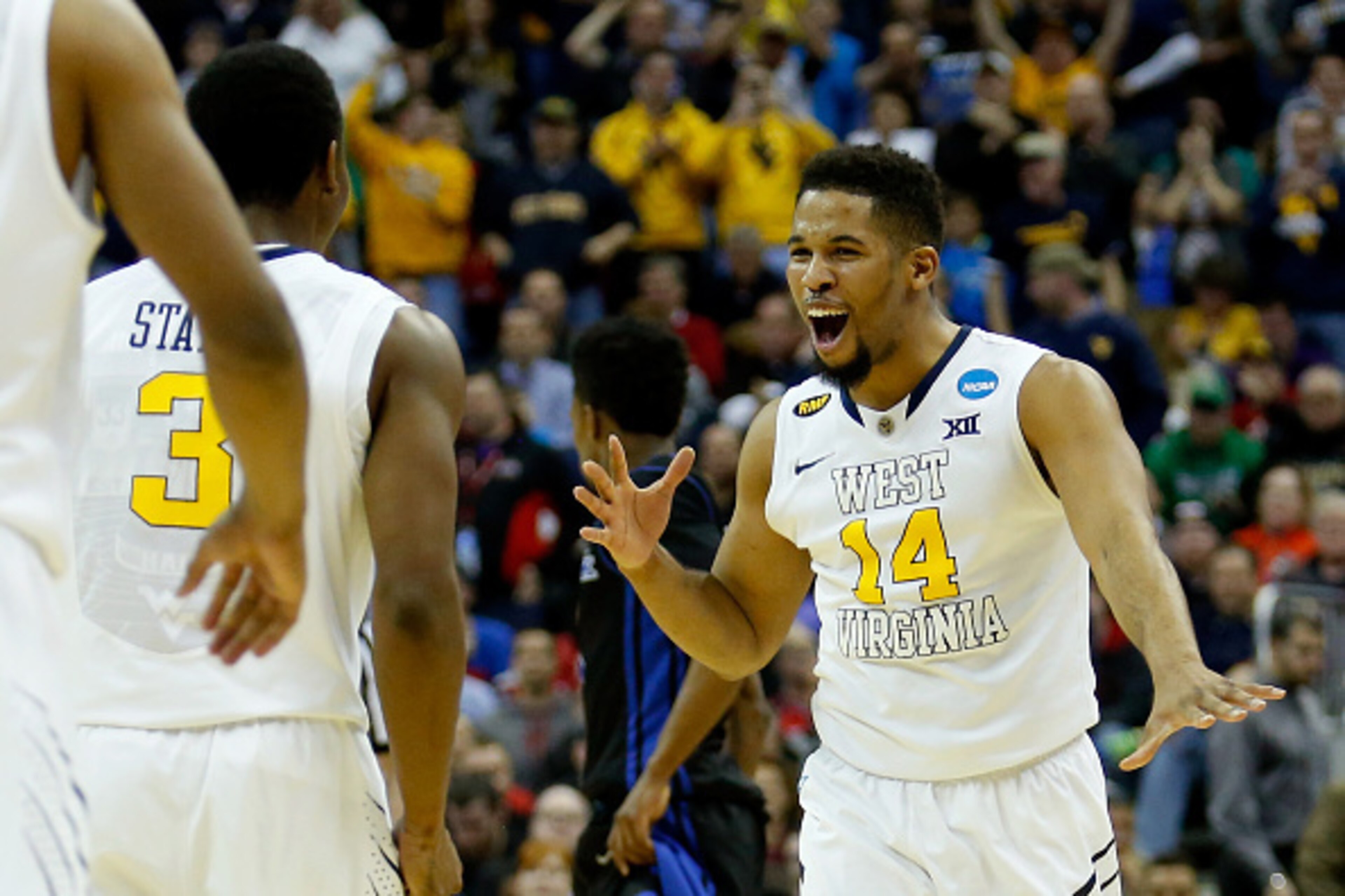 COLUMBUS, OH - MARCH 20: Juwan Staten #3 and Gary Browne #14 of the West Virginia Mountaineers celebrate after defeating the Buffalo Bulls during the second round of the 2015 NCAA Men's Basketball Tournament at Nationwide Arena on March 20, 2015 in Colum COLUMBUS, OH - MARCH 20: Juwan Staten #3 and Gary Browne #14 of the West Virginia Mountaineers celebrate after defeating the Buffalo Bulls during the second round of the 2015 NCAA Men's Basketball Tournament at Nationwide Arena on March 20, 2015 in Colum